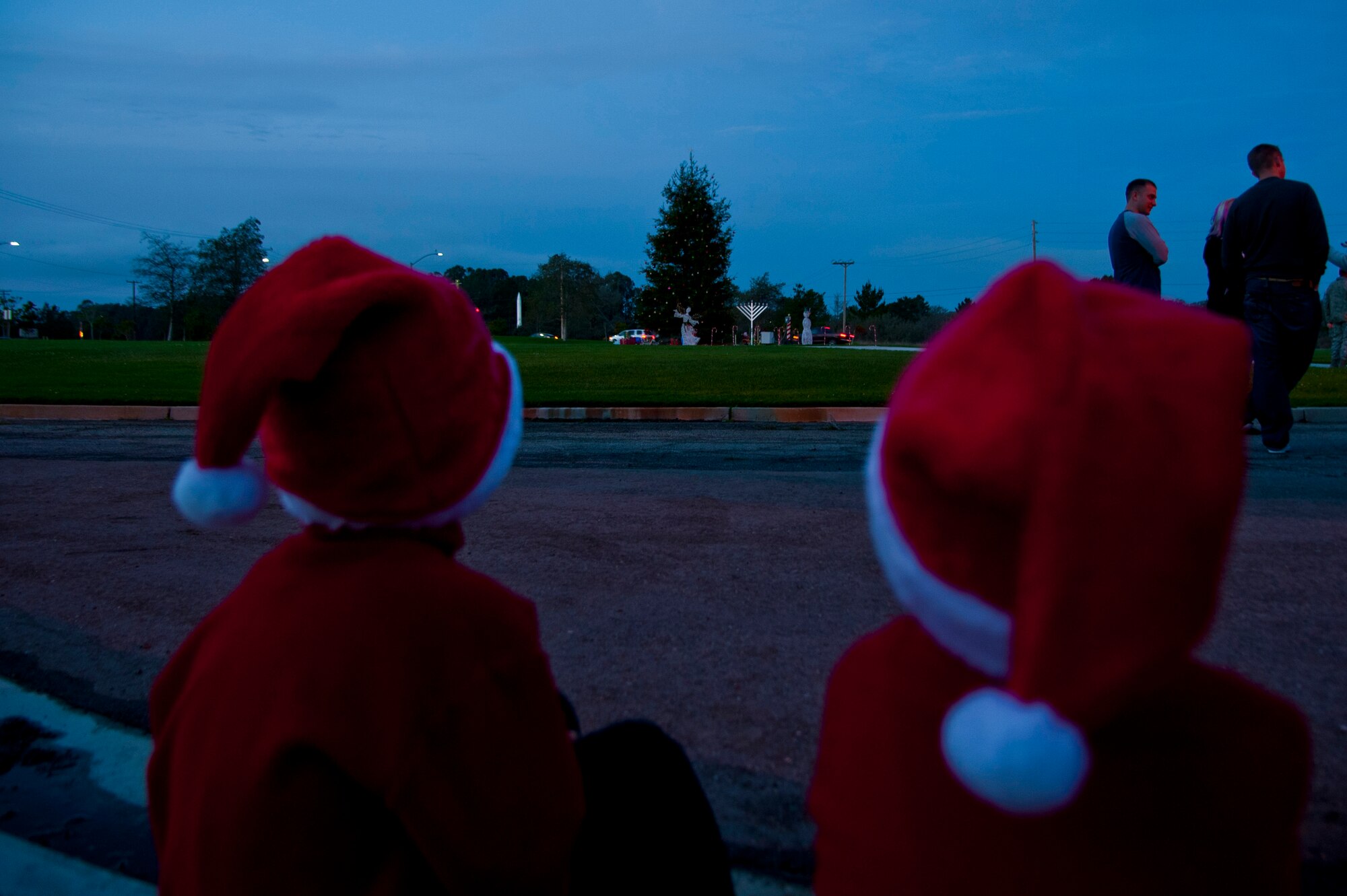VANDENBERG AIR FORCE BASE, Calif. – Feeling festive in their Santa hats; two little children wait patiently for the light show at the annual Tree Lighting Ceremony event to begin here Tuesday, Dec. 4, 2012. The event included carols, hot chocolate, the lighting of the tree and a visit from Santa Claus. (U.S. Air Force photo/Senior Airman Lael Huss)