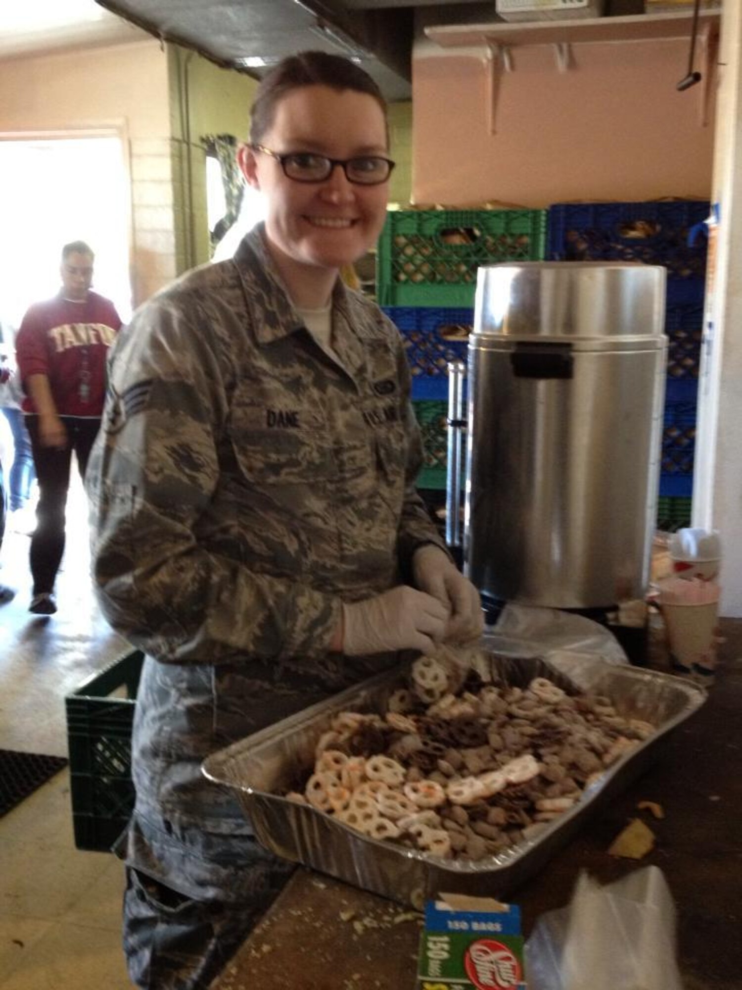 Senior Airman Jennifer Dane, 612th Air and Space Operations Center, prepares meals for hundreds of homeless individuals in Tucson, Ariz., Dec. 5. Members of 12th Air Force dedicated 3 hours of their time volunteering their services at Casa Maria, a Tucson organization dedicated to helping those in need. (USAF photo by Master Sgt. Kelly Ogden/Released).