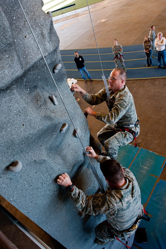 Col. Mark Weatherington (right), 28th Bomb Wing commander, and Chief Master Sgt. Kevin Peterson, 28th BW command chief, climb the newly-installed rock climbing wall in the Pride Hangar on Ellsworth Air Force Base, S.D., Dec. 3, 2012. The wall will be officially available for use on Dec. 17, and climbers must have a member trained on how to oversee climbing activities present at all times to ensure safety. For scheduling and more information, call Outdoor Recreation at (605) 385-2996. (U.S. Air Force photo by Airman 1st Class Kate Thornton-Maurer/Released)