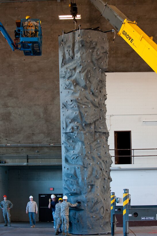 Members of the 28th Civil Engineer Squadron and 28th Force Support Squadron install a rock climbing wall in the Pride Hangar on Ellsworth Air Force Base, S.D., Dec. 3, 2012. The 32-foot wall was installed as part of Outdoor Recreation’s outdoor adventure program, designed to get Airmen and families more involved with outdoor activities and teach them how to participate in them safely. (U.S. Air Force photo by Airman 1st Class Kate Thornton-Maurer/Released)