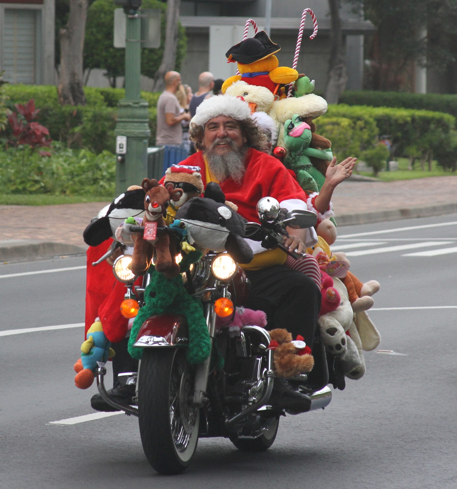 A motorcyclist parades through Oahu Dec. 2 in a display aimed at garnering public support for the annual Toys for Tots campaign. Approximately 6,000 motorcycle enthusiasts gathered in Waikiki for the parade which began at Magic Island and ended at the Kapiolani Community College.  More than 8,000 unwrapped toys were collected for distribution to less fortunate Hawaiian "keiki." (U.S. Air Force photo by Maj. David Eisenbrey)