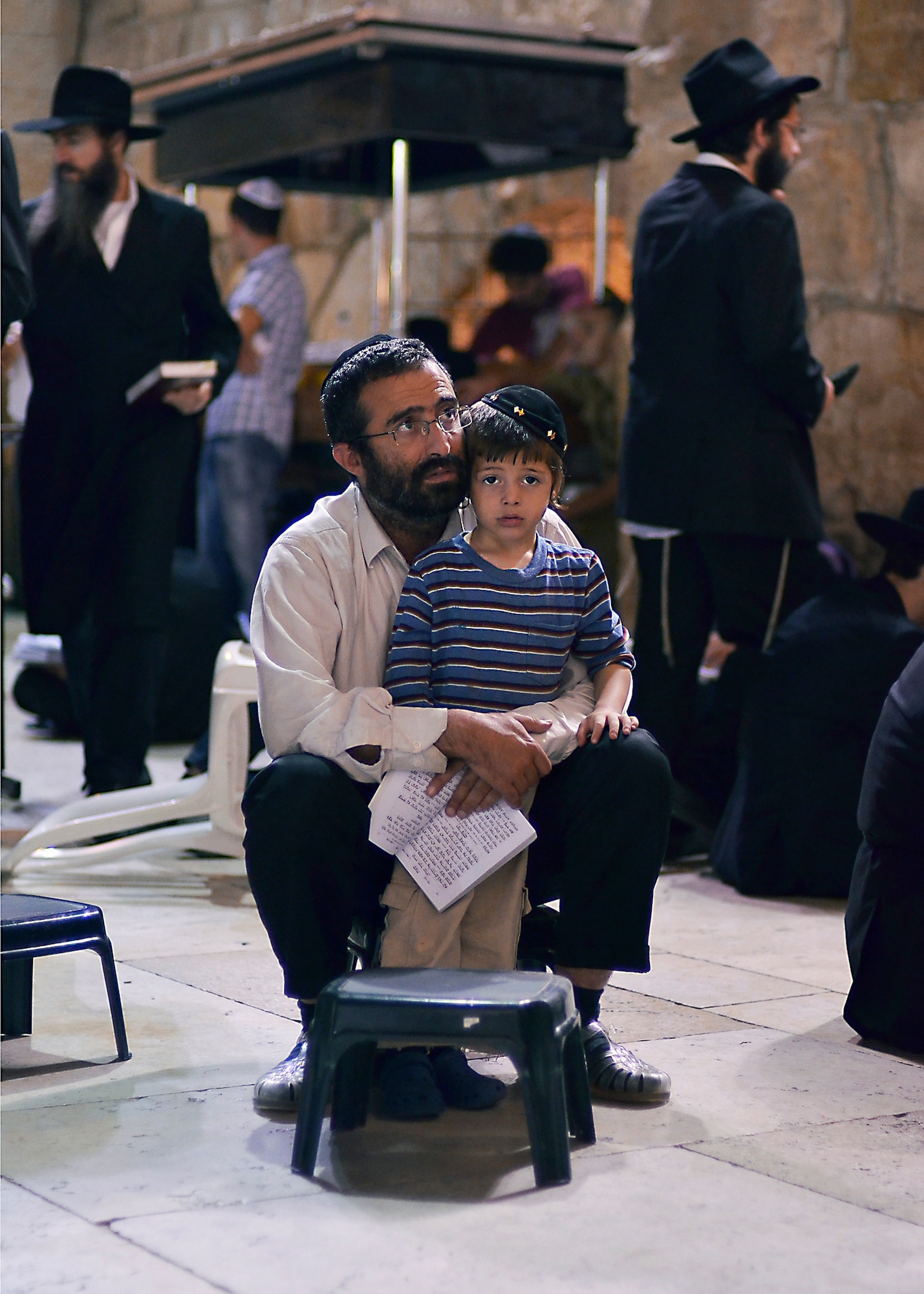 WRIGHT-PATTERSON AIR FORCE BASE, Ohio - A father sings prayers with his son by the Wailing Wall in Jerusalem, Israel. Thousands of people gathered near Western Wall July 29, 2012, to mourn the 86 Israelis who died during a terrorist bombing in 1994. (U.S. Air Force photo/Staff Sgt. Mikhail Berlin)
