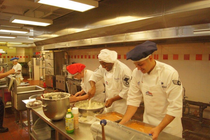 Airmen from Joint Base Pearl Harbor-Hickam, Hawaii, prepare a Thanksgiving Meal Nov. 22 at the Hickam Dining Facility. Base leaders and spouses took time to serve food to base Airmen during the holidays. (Courtesy photo)