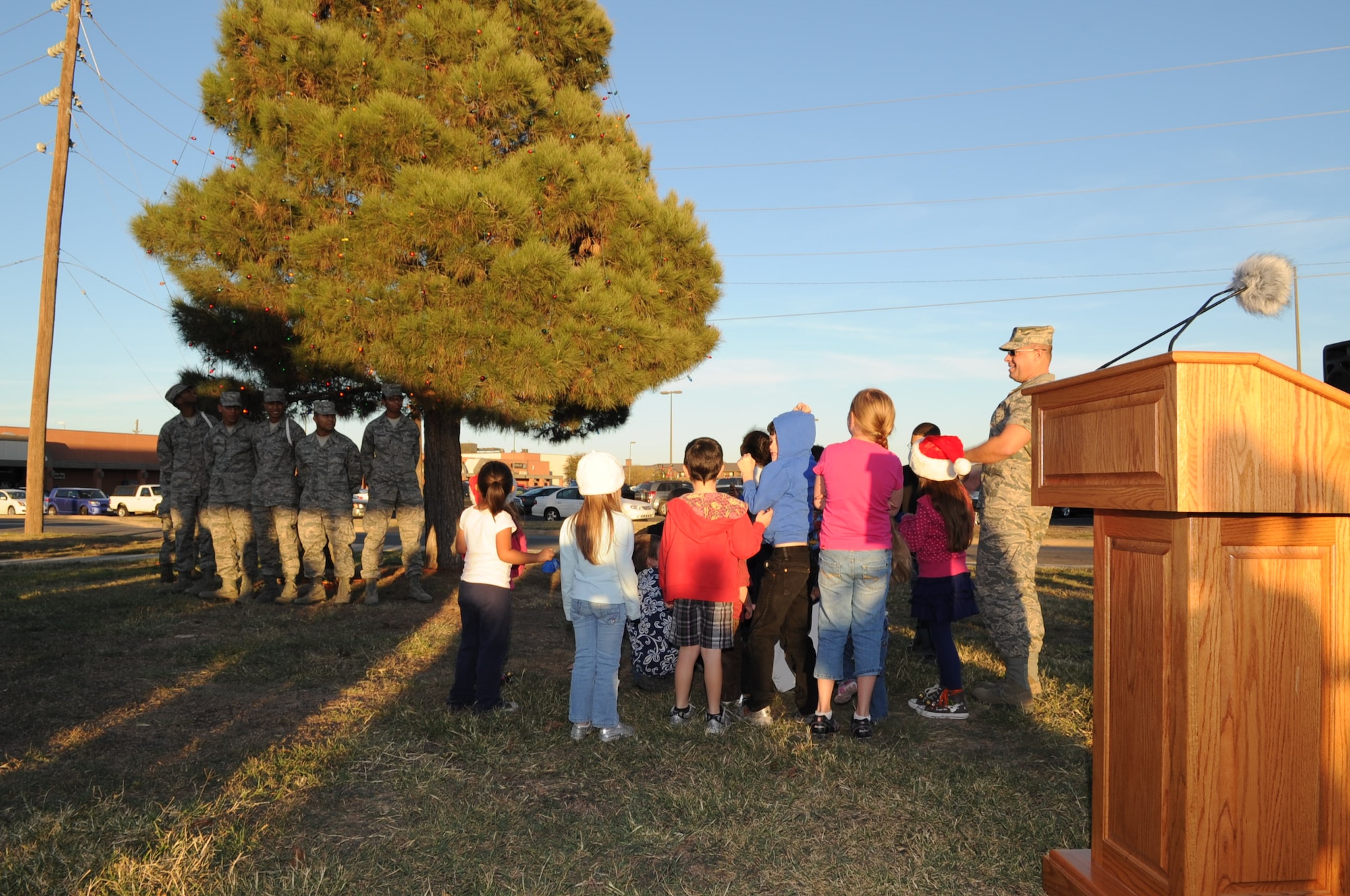 GOODFELLOW AIR FORCE BASE, Texas – A group of children turn on the lights on the Christmas tree near the Taylor Chapel here Dec. 4. The tree was light for the holidays after a speech given by Col. Mark Damiano, 17th Training Wing commander. (U.S. Air Force photo/ Staff Sgt. Laura McFarlane)