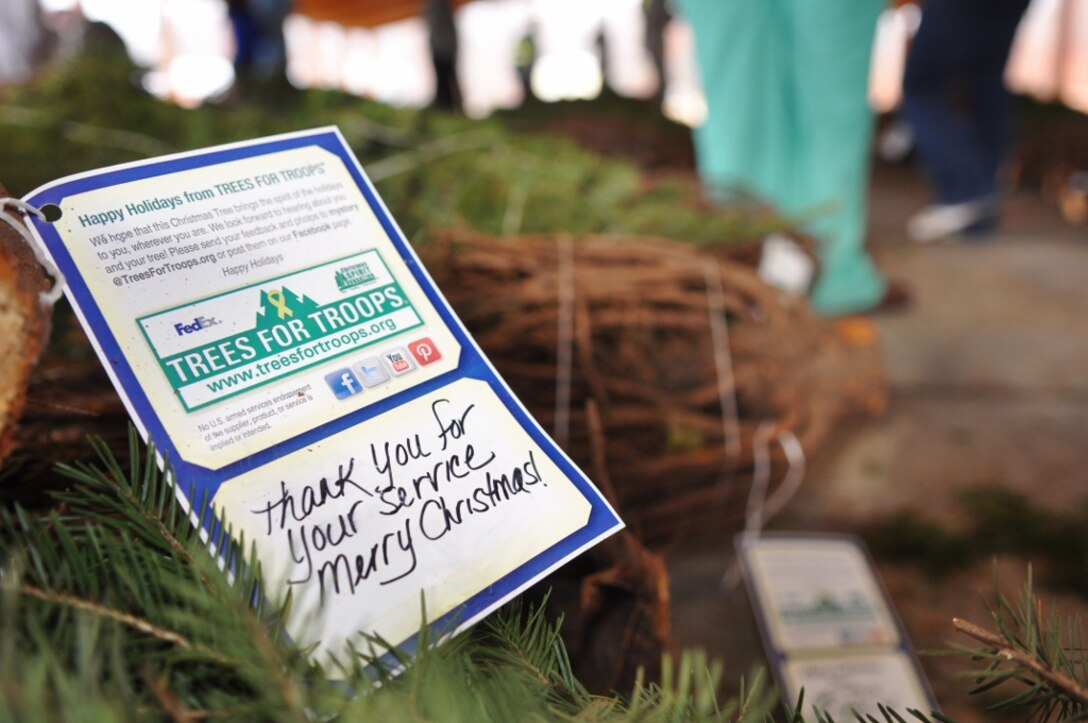 A tag bearing holiday wishes is affixed to a Christmas tree awaiting pickup at the annual “Trees for Troops” Christmas Tree giveaway at Fort Eustis, Va., Dec. 5, 2012. Patrons at two Christmas tree farms donated more than 500 trees, which were shipped to Fort Eustis and given free of charge to Service members and their families. (U.S. Air Force photo by Senior Airman Jason J. Brown/Released)