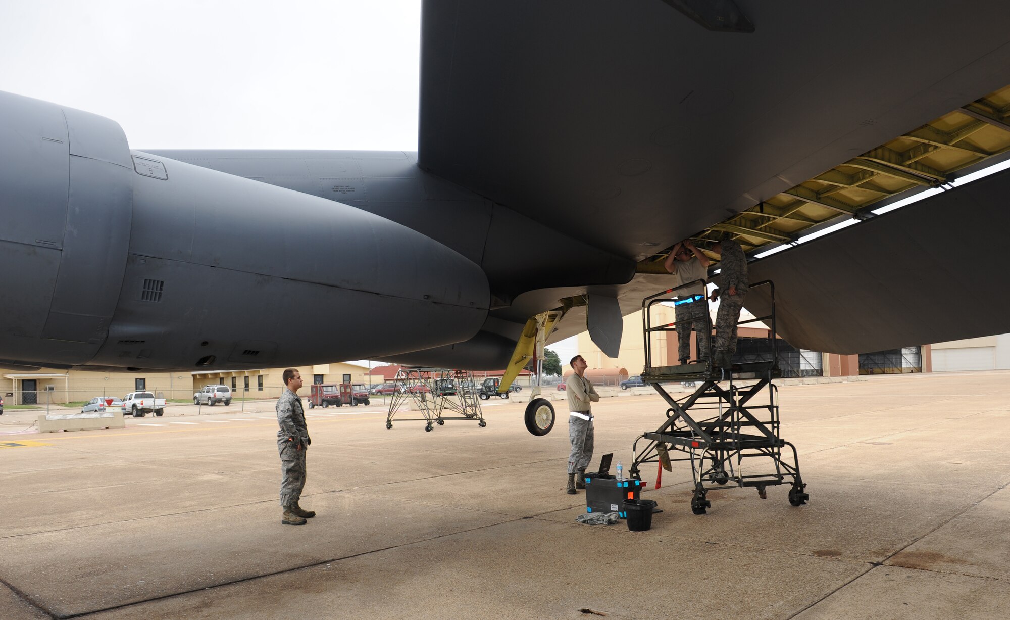Hydraulics technicians from the 20th Aircraft Maintenance Unit reinstall a spoiler metering valve on a B-52H Stratofortress on Barksdale Air Force Base, La., Dec. 5. The spoiler metering valve allows the B-52 flight controls to perform aerial maneuvers. During any type of aircraft maintenance, Airmen are required to work with a partner for safety and support. (U.S. Air Force photo/Airman 1st Class Benjamin Gonsier)
