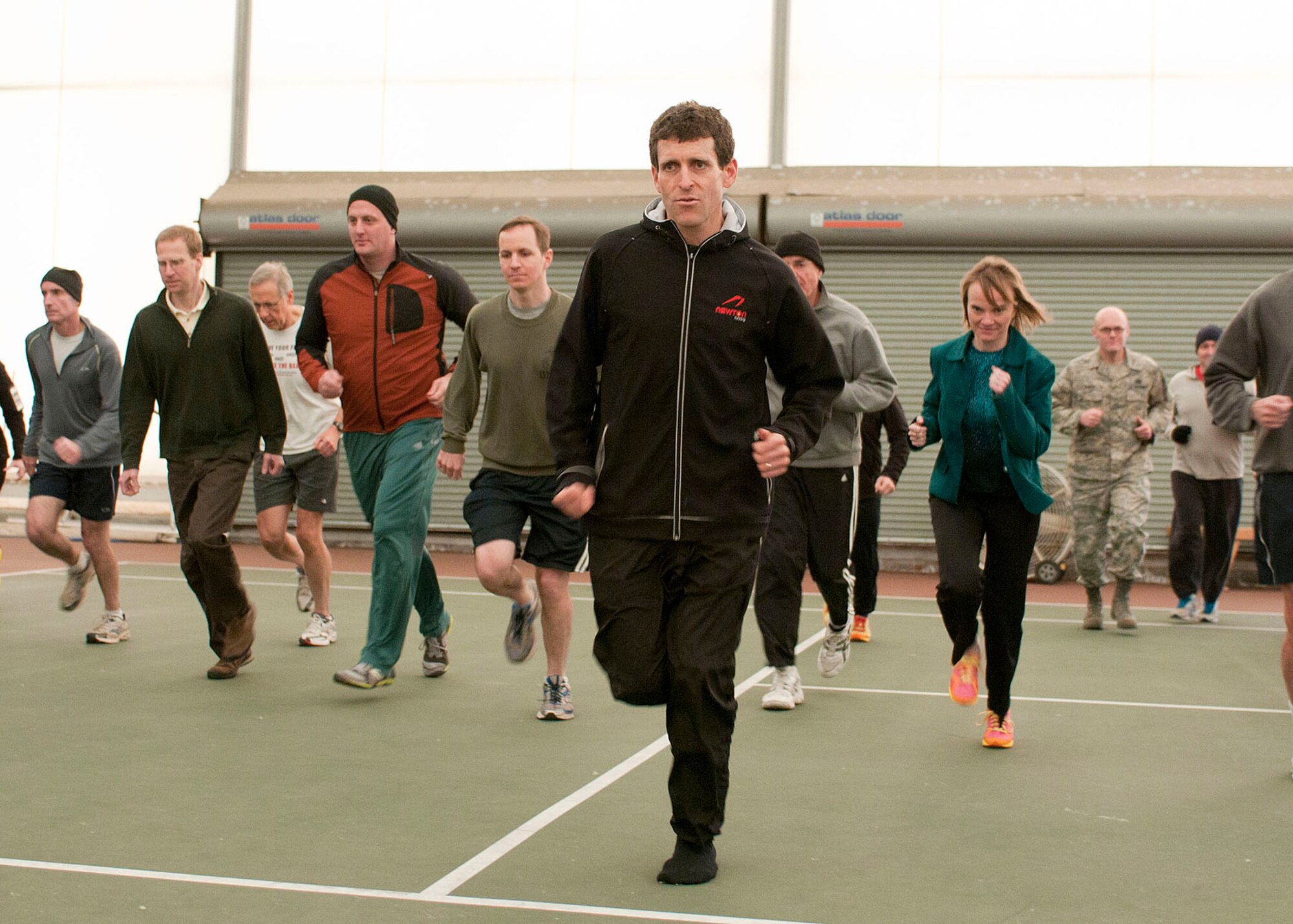 HANSCOM AIR FORCE BASE, Mass. -- Lt. Col. Mark Cucuzella, a medical consultant for the Air Force Marathon, demonstrates proper running form during a running clinic at the Fitness and Sports Center tennis bubble Nov. 28. Cucuzella shared information on proper techniques and methods for injury-free running. (U.S. Air Force photo by Mark Wyatt)