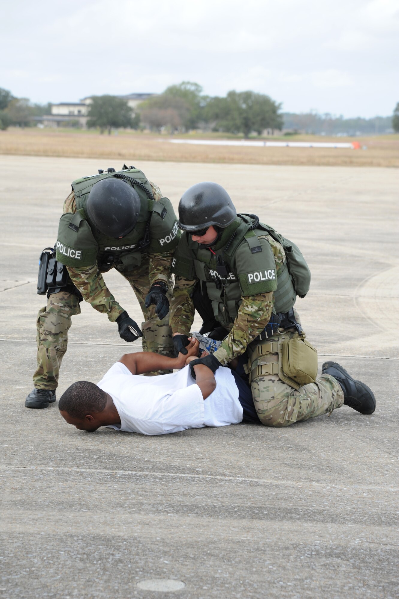 Second Lt. Brandon Williams, 81st Training Wing, portrays a hijacker who is being apprehended by the Biloxi Police Department Special Response Team during an anti-hijacking exercise on the flightline at Keesler Air Force Base, Miss., Dec. 4, 2012. The exercise scenario consisted of a disgruntled Airman, who after being denied leave during the holidays, created a fake Air Force leave form to get on a flight and hijack the aircraft to fly home.  (U.S. Air Force photo by Kemberly Groue)