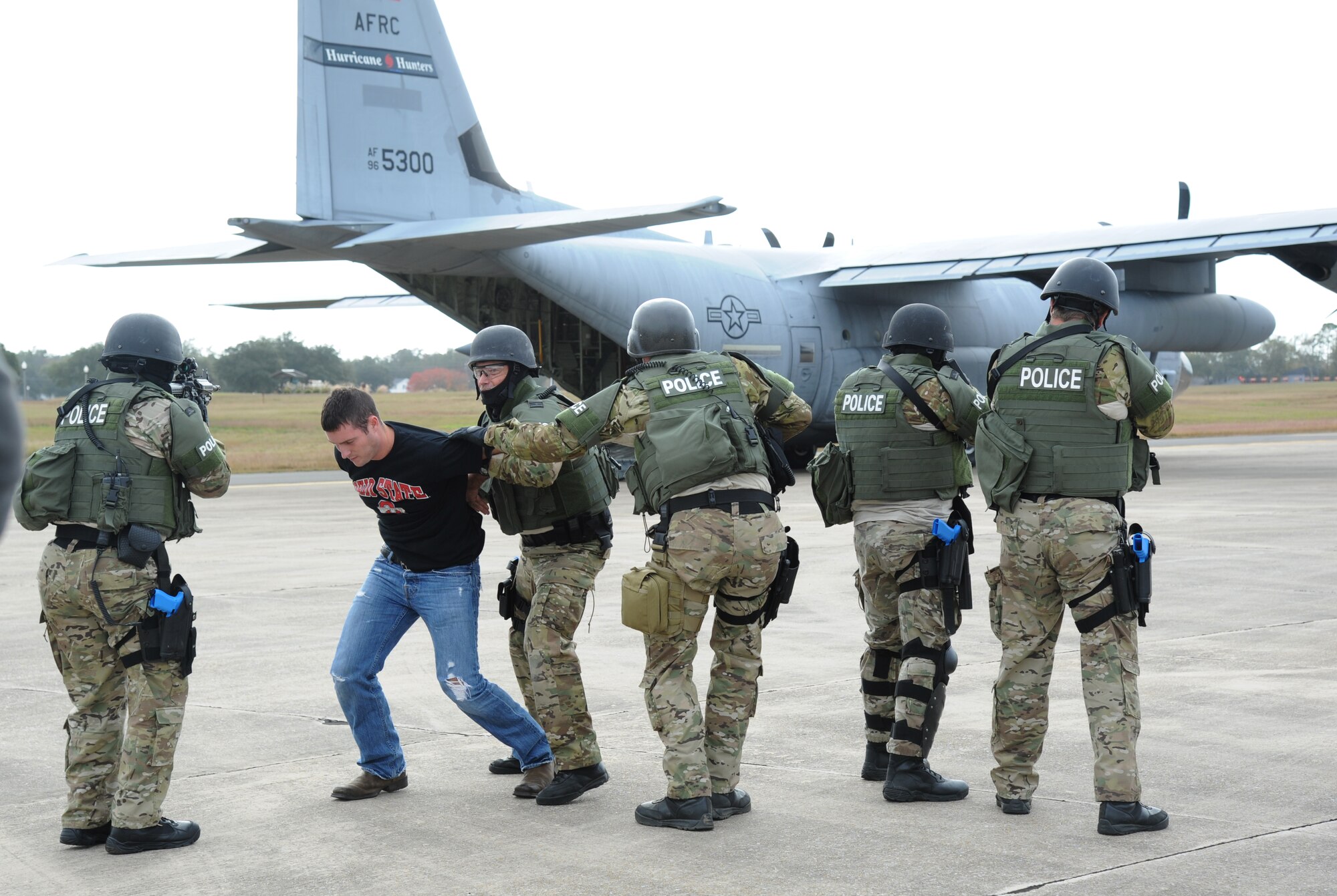 Staff Sgt. Cody Spitler, 81st Force Support Squadron, portrays a hostage who is being apprehended for safety purposes by the Biloxi Police Department Special Response Team upon his release from the aircraft during an anti-hijacking exercise on the flightline at Keesler Air Force Base, Miss., Dec. 4, 2012. The exercise scenario consisted of a disgruntled Airman, who after being denied leave during the holidays, created a fake Air Force leave form to get on a flight and hijack the aircraft to fly home.  (U.S. Air Force photo by Kemberly Groue)