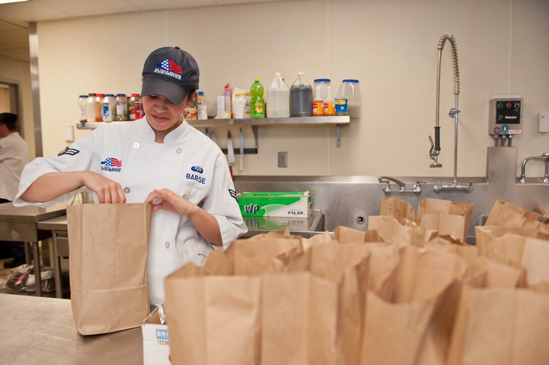 Airman 1st Class Alexandria Barse, 28th Force Support Squadron flight kitchen cook, prepares lunches in the flight kitchen at Ellsworth Air Force Base, S.D., Dec. 4, 2012. The flight kitchen serves more than 1,300 hot meals every month to Airmen from a variety of units supporting flightline operations at Ellsworth. (U.S. Air Force photo by Airman 1st Class Zachary Hada/Released)