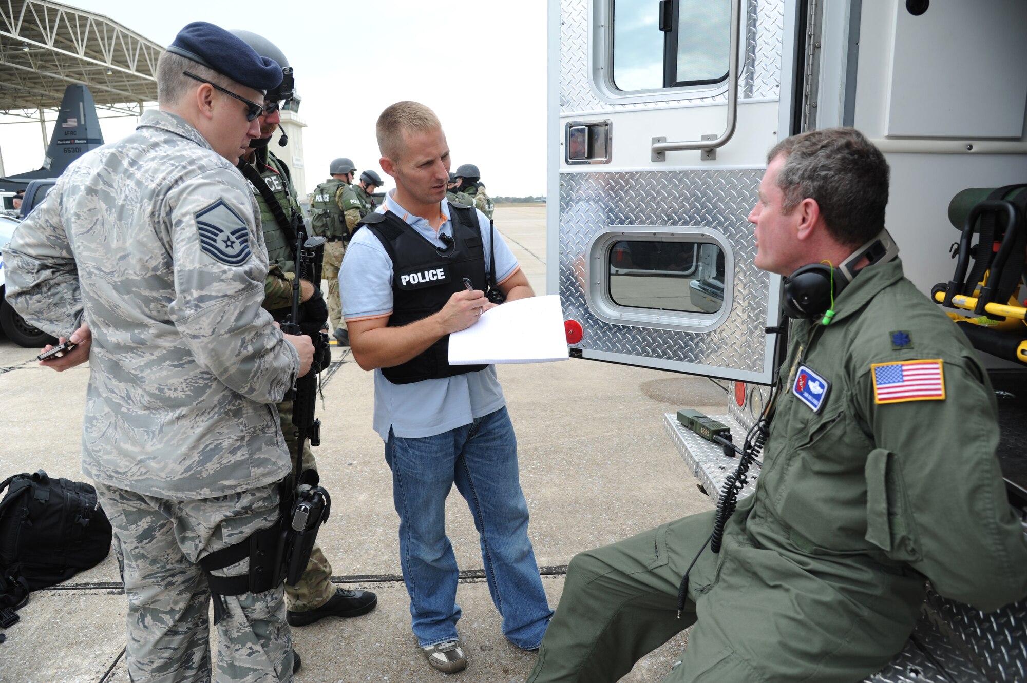 Master Sgt. Michael Smith, 81st Security Forces Squadron, stands by as Investigator Matthew James, 81st SFS, questions one of the “hostages,” Lt. Col. John Gallagher, 53rd Weather Reconnaisance Squadron, following his release from the aircraft during an anti-hijacking exercise on the flightline at Keesler Air Force Base, Miss., Dec. 4, 2012. The exercise scenario consisted of a disgruntled Airman, who after being denied leave during the holidays, created a fake Air Force leave form to get on a flight and hijack the aircraft to fly home.  (U.S. Air Force photo by Kemberly Groue)