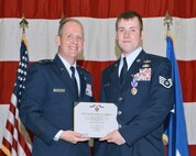 Wisconsin Air National Guard Staff Sgt. Timothy I. Donnan, of the 115th Explosive Ordnance Disposal flight, receives the Purple Heart from Maj. Gen. Donald P. Dunbar, adjutant general of Wisconsin, in a ceremony at Truax Field, Madison, Wis., Dec. 3. Donnan was awarded the Purple Heart for injuries received from a roadside bomb while deployed to Afghanistan. (U.S. Air Force photo by Master Sgt. Paul Gorman)