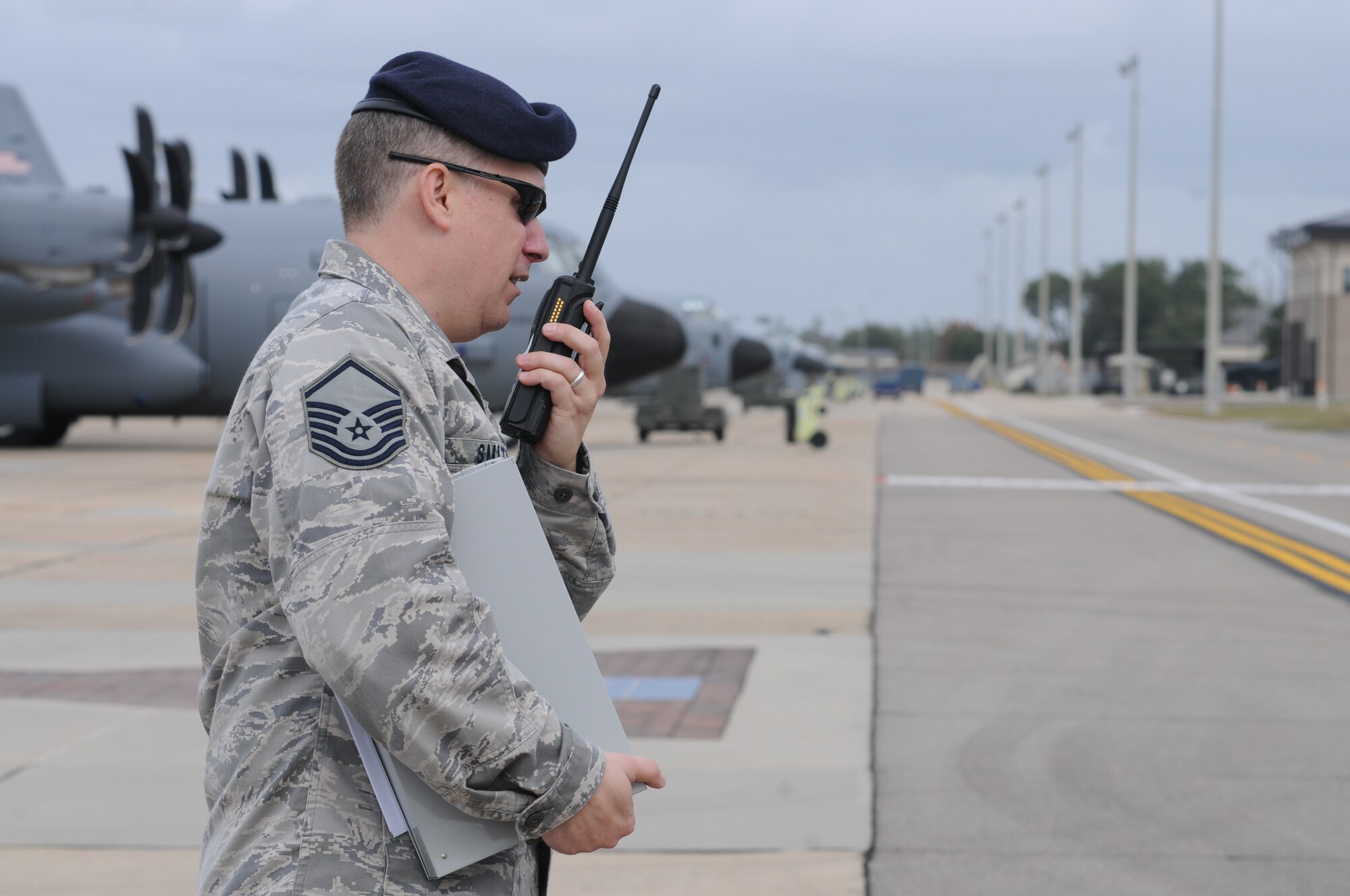 Master Sgt. Michael Smith, 81st Security Forces Squadron, relays pertinent information on-scene back to his squadron personnel during an anti-hijacking exercise on the flightline at Keesler Air Force Base, Miss., Dec. 4, 2012. The exercise scenario consisted of a disgruntled Airman, who after being denied leave during the holidays, created a fake Air Force leave form to get on a flight and hijack the aircraft to fly home.  (U.S. Air Force photo by Kemberly Groue)