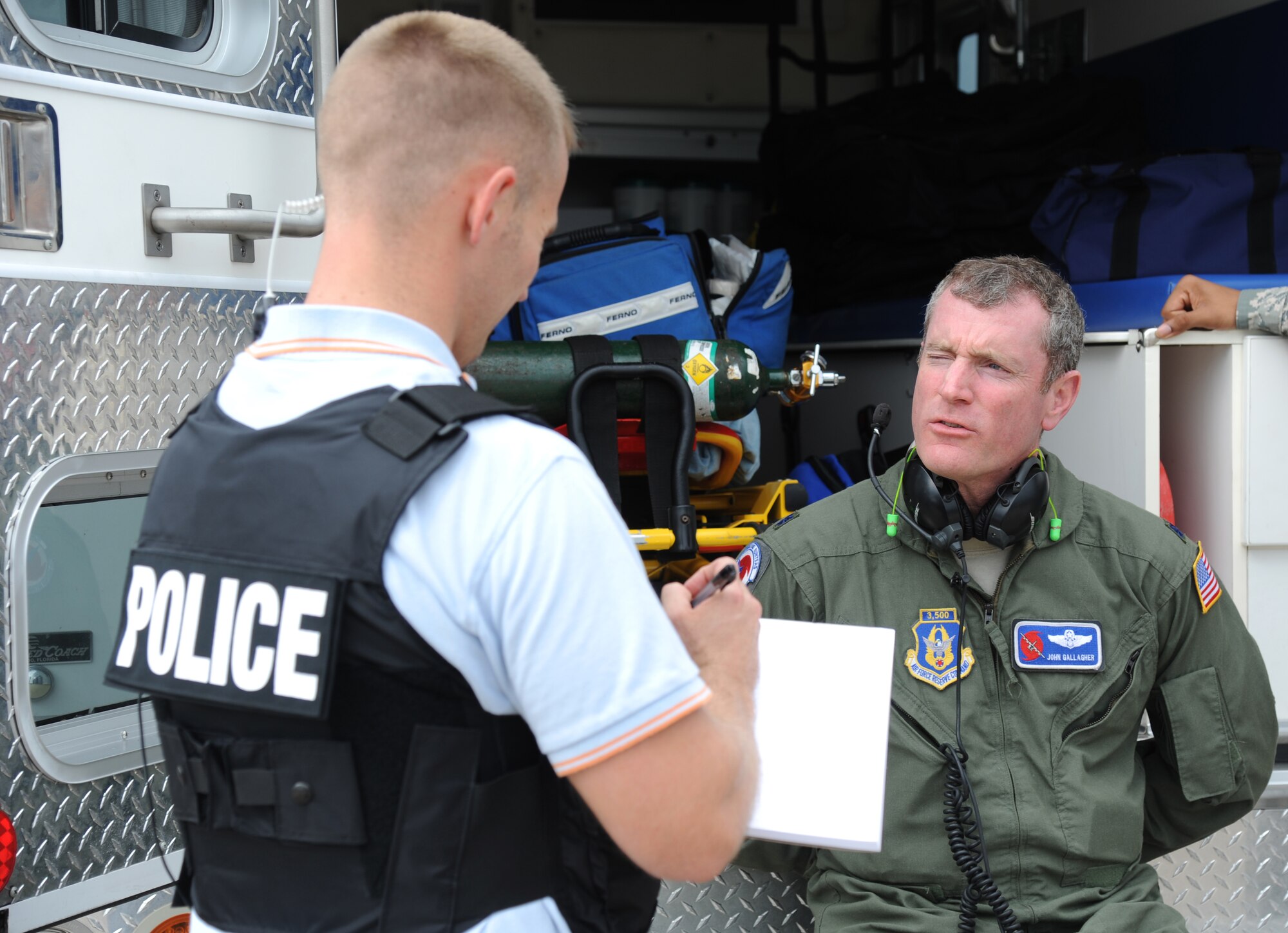 Investigator Matthew James, 81st Security Forces Squadron, questions one of the hostages, Lt. Col. John Gallagher, 53rd Weather Reconnaisance Squadron, following his release from the aircraft during an anti-hijacking exercise on the flightline at Keesler Air Force Base, Miss., Dec. 4, 2012. The exercise scenario consisted of a disgruntled Airman, who after being denied leave during the holidays, created a fake Air Force leave form to get on a flight and hijack the aircraft to fly home.  (U.S. Air Force photo by Kemberly Groue)