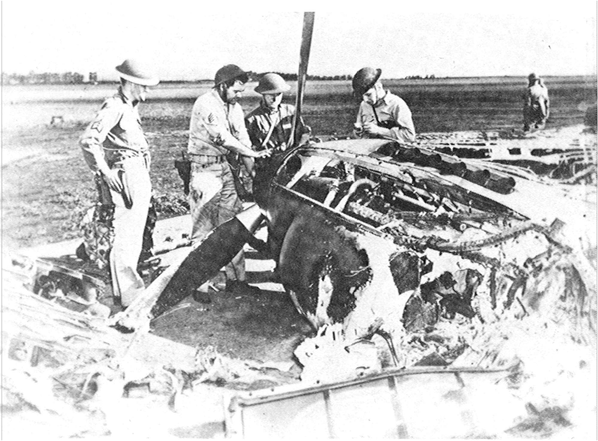 Resourceful aircrews remove parts from a P-40 destroyed in the Dec. 7, 1941 attack on Wheeler Air Base for us on other repairable aircraft.   