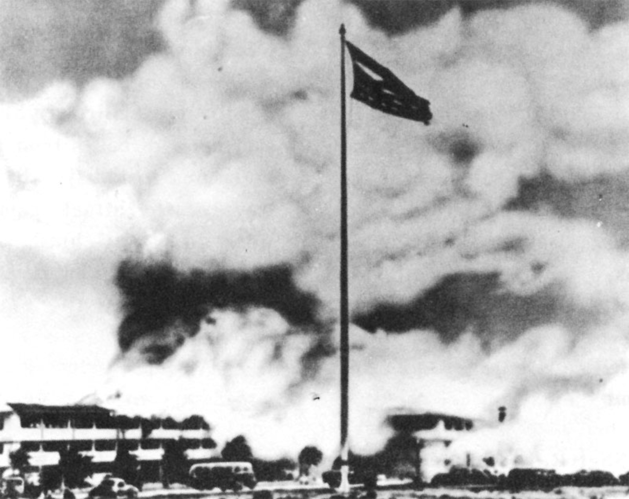 Old Glory waves over Hickam Field, bearing silent witness to the brutality of the Japanese attack Dec. 7, 1941. This same flag later flew above the United Nations charter meeting in San Francisco, over the Big Three conference at Potsdam, and above the White House Aug. 14, 1945 when the Japanese accepted terms of surrender. It was part of a historical display at the Air Force Academy until returned for permanent display at Hickam Air Force Base in 1980. (Air Force Photo)      