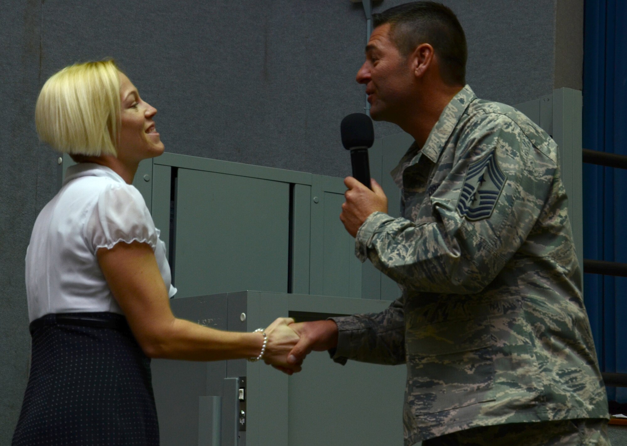 During the 920th Rescue Wing enlisted call, held over the December unit training assembly, Command Chief Master Sgt. Timothy Bianchi for his first time coined a civilian, Ms. Katy Mulligan, for her dedication to the wing as an education liaison for Reservists. (U.S. Air Force photo/Senior Airman Natasha Dowridge)