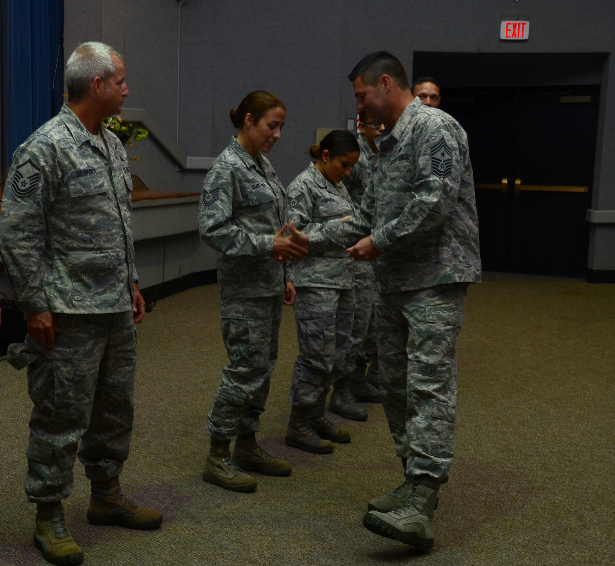 During the 920th Rescue Wing enlisted call, held over the December unit training assembly, Command Chief Master Sgt. Timothy Bianchi coined the 920th RQW enlisted Airmen that achieved the score of 100 on their last PT test. (U.S. Air Force photo/Senior Airman Natasha Dowridge)