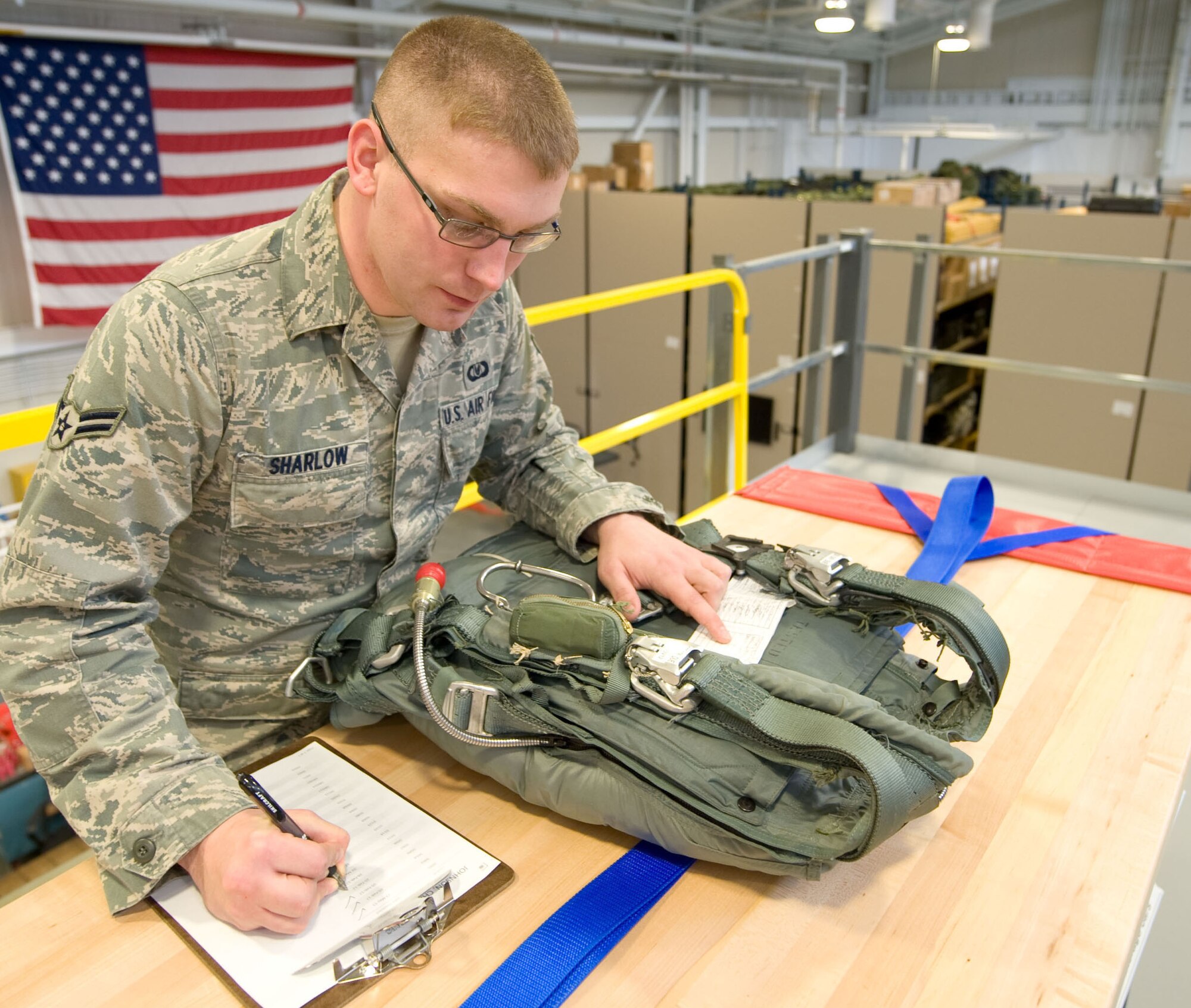 Airman 1st Class Chris Sharlow, 436th Operations Support Squadron Aircrew Flight Equipment journeyman, performs an inspection on a parachute at Dover Air Force Base, Del. on Nov. 30, 2012. He is the creator of a new computer program used to easily track thousands of accountable aircrew equipment items. Sharlow's program is known as the Flight Equipment Automated Records Systems (FEARS) and is being used to ensure tracking and on-time inspections of items critical to safe, efficient mission accomplishment. (U.S. Air Force photo by Greg L. Davis)