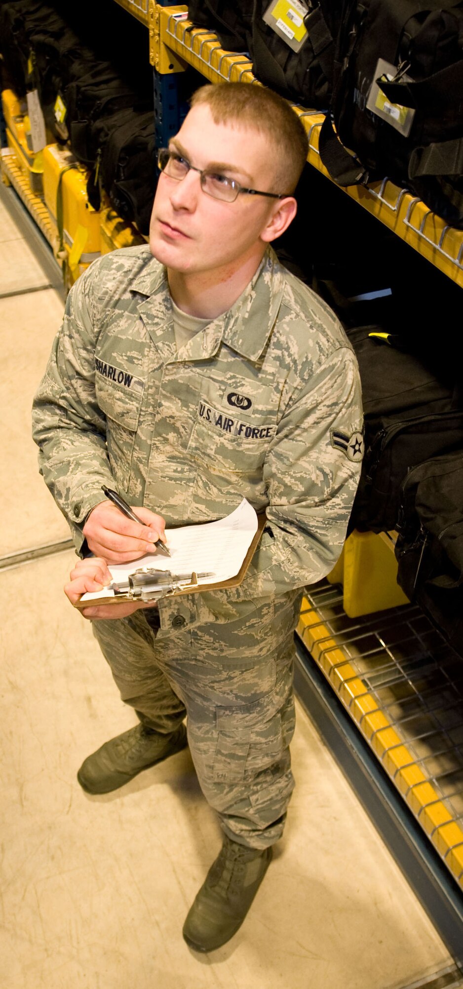 Airman 1st Class Chris Sharlow, 436th Operations Support Squadron Aircrew Flight Equipment journeyman, takes an inventory of Aircrew Flight Equipment at Dover AFB, Del. on Nov. 30, 2012. He is the creator of a new computer program used to easily track thousands of accountable aircrew equipment items. Sharlow's program is known as the Flight Equipment Automated Records Systems (FEARS) and is being used to ensure tracking and on-time inspections of items critical to safe, efficient mission accomplishment. (U.S. Air Force photo by Greg L. Davis)