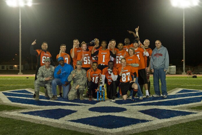 The 99th Communications Squadron celebrates winning the 2012 intramural championship against the 99th Security Forces Squadron Nov 29, 2012 at Nellis Air Force Base’s Warrior Fitness Center Football Field. The Communications team has won the intramural football championship two years in a row. (U.S. Air Force Photo by Senior Airman Daniel Hughes)