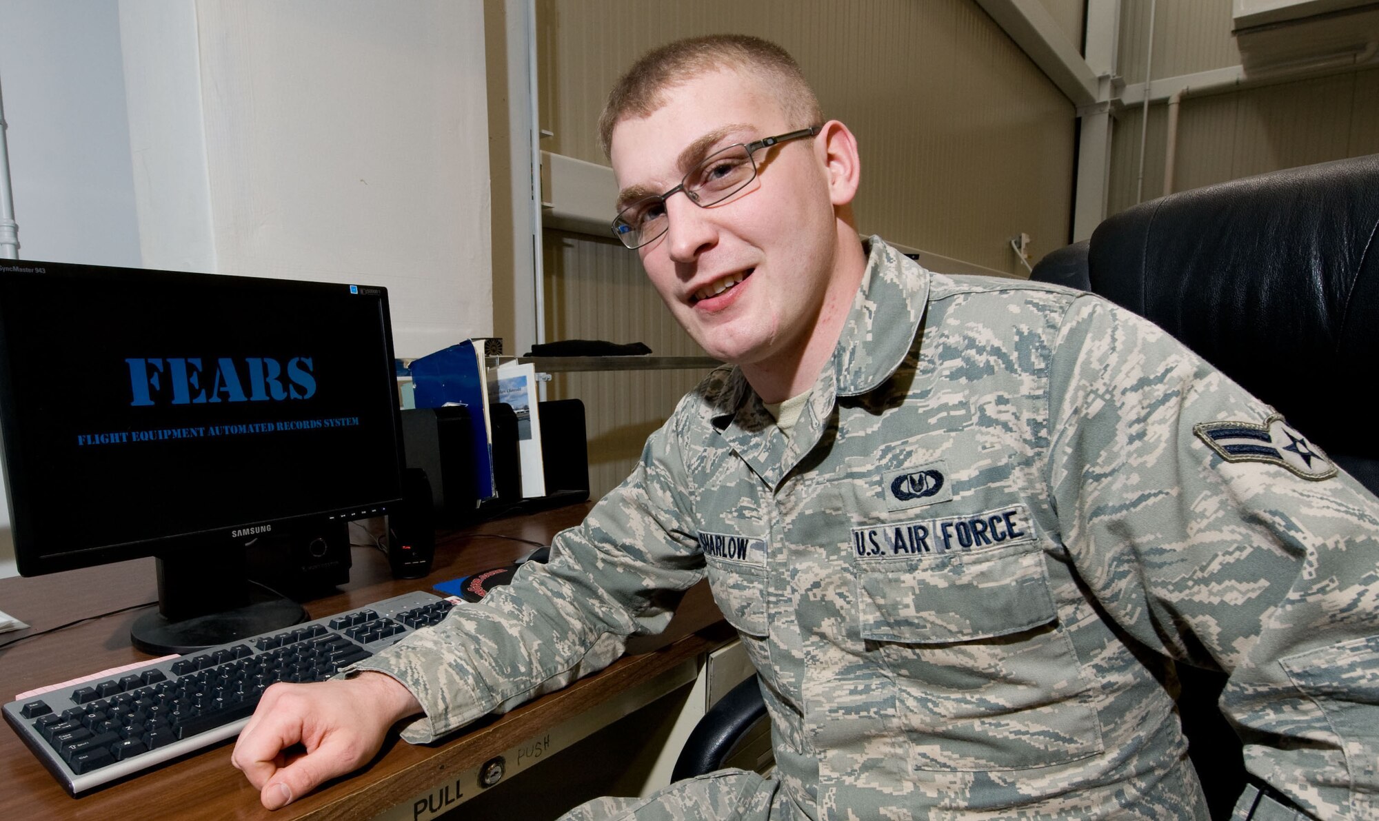 Airman 1st Class Chris Sharlow, 436th Operations Support Squadron Aircrew Flight Equipment journeyman, poses for a photo at Dover Air Force Base, Del., on Nov. 30, 2012. He is the creator of a new computer program used to easily track thousands of accountable aircrew equipment items. Sharlow's program is known as the Flight Equipment Automated Records Systems (FEARS) and is being used to ensure tracking and on-time inspections of items critical to safe, efficient mission accomplishment. (U.S. Air Force photo by Greg L. Davis)