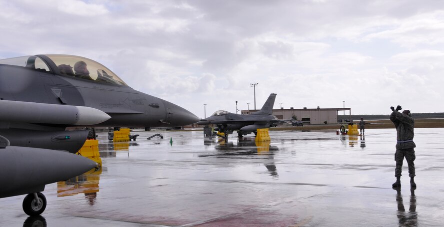 Senior Airman Mark Edwards, 482nd Fighter Wing crew chief, marshals an F-16, piloted by Lt. Col. Joseph Feheley, after a sortie in support of the recent Operational Readiness Inspection at Homestead Air Reserve Base, Dec. 1. Col. Donald R. Lindberg, 482nd Fighter Wing Commander, praised the Airmen of the 482nd FW for their efforts and accomplishments over this past year. "This has been a year filled with challenges that have pushed us all to perform at higher levels," said Lindberg. "We met all challenges head-on, culminating with passing our Operational Readiness Inspection and supporting the Wings Over Homestead air show. Thank you all for everything you've done this past year to contribute to this end."