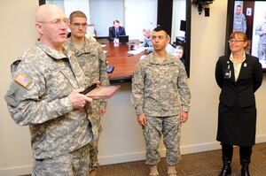 U.S. Army Gen. Robert W. Cone, commanding general of the U.S. Army Training and Doctrine Command, presents the Director of Safety Composite Risk Management Award to Sgt. 1st Class Randolph E. Hagin, TRADOC Band safety and security noncommissioned officer in charge, while Maj. Leonel A. Pena, TRADOC Band commander, as Susan M. George, TRADOC safety officer, look on at TRADOC Headquarters at Fort Eustis, Va., Dec. 3, 2012. Cone congratulated the band on its yearlong run of no Class A safety violations. (U.S. Army photo by Steven
Schneider/Released)