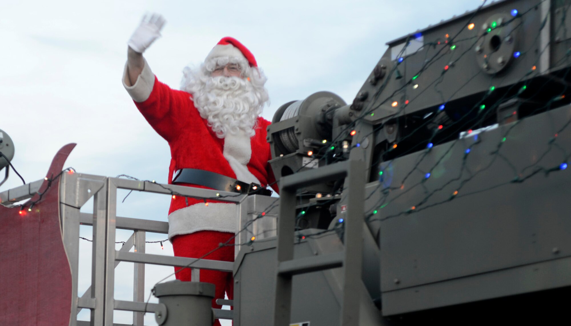 Santa Claus waves to the crowd during the Christmas Parade Dec. 4, 2012, in base housing on Dover Air Force Base, Del. The parade featured a variety of vehicles and was followed by a tree lighting ceremony at the base chapel. (U.S. Air Force photo by Tech. Sgt. Chuck Walker)