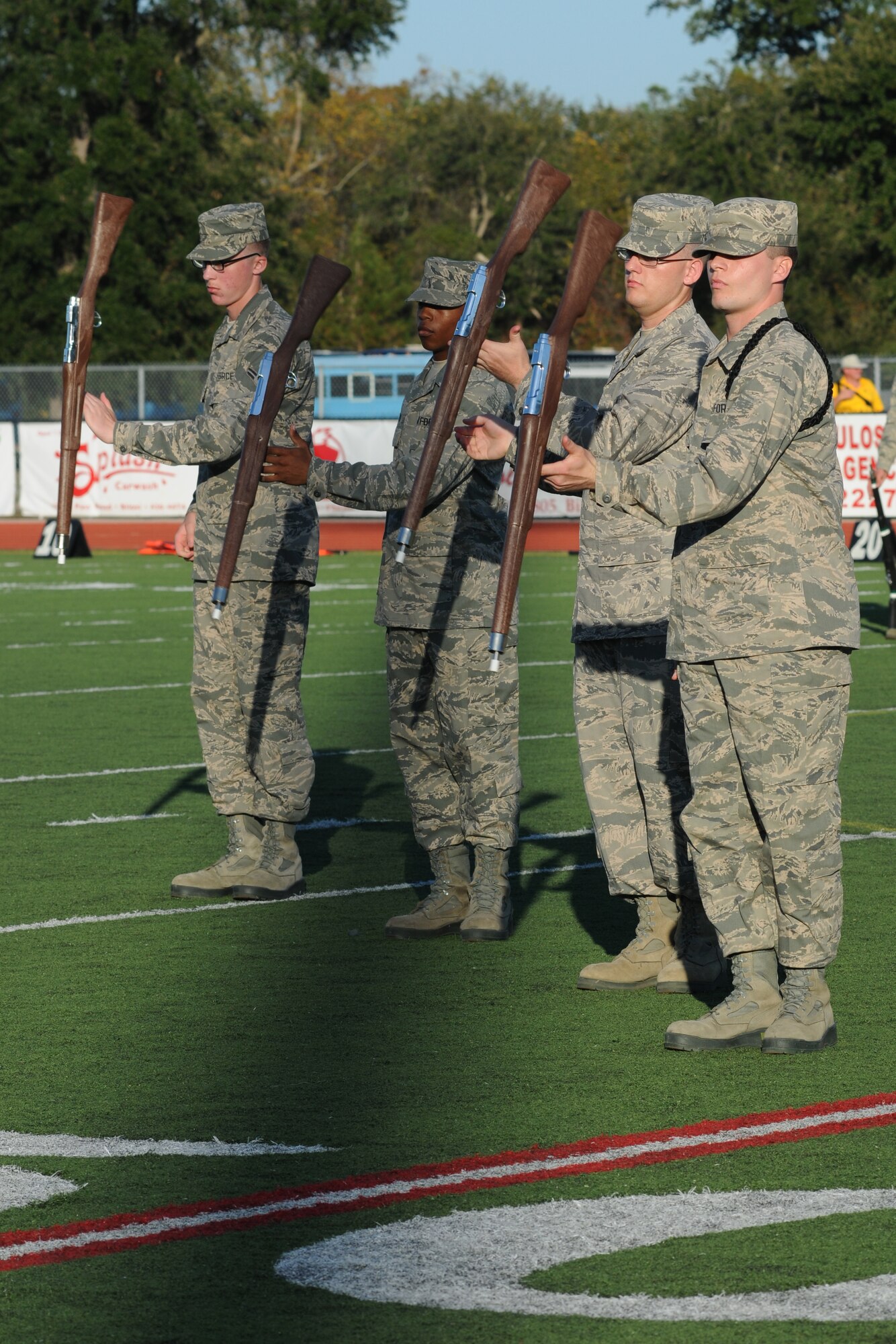 Members of the 336th Training Squadron drill team perform in a drill down competition during half time at the 2012 Mississippi Bowl at the Biloxi High School football stadium Dec. 2, 2012. The 336th TRS was selected as the winner of the competition by audience applause.  Other participation from Keesler Air Force Base, Miss., included the 50-State Flag Team, the Honor Guard, and a C-130J Hercules fly over by the 403rd Wing.   (U.S. Air Force photo by Kemberly Groue)
