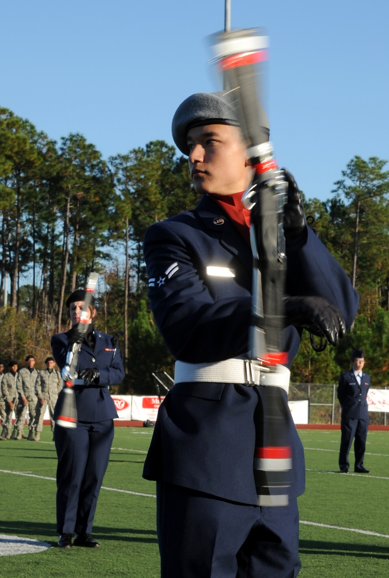 Airman 1st Class Kyle Harayda, 335th Training Squadron, spins his weapon in a drill down competition during half time at the 2012 Mississippi Bowl at the Biloxi High School football stadium Dec. 2, 2012. The 336th Training Squadron was selected as the winner of the competition by audience applause.  Other participation from Keesler Air Force Base, Miss., included the 50-State Flag Team, the Honor Guard, and a C-130J Hercules fly over by the 403rd Wing.   (U.S. Air Force photo by Kemberly Groue)