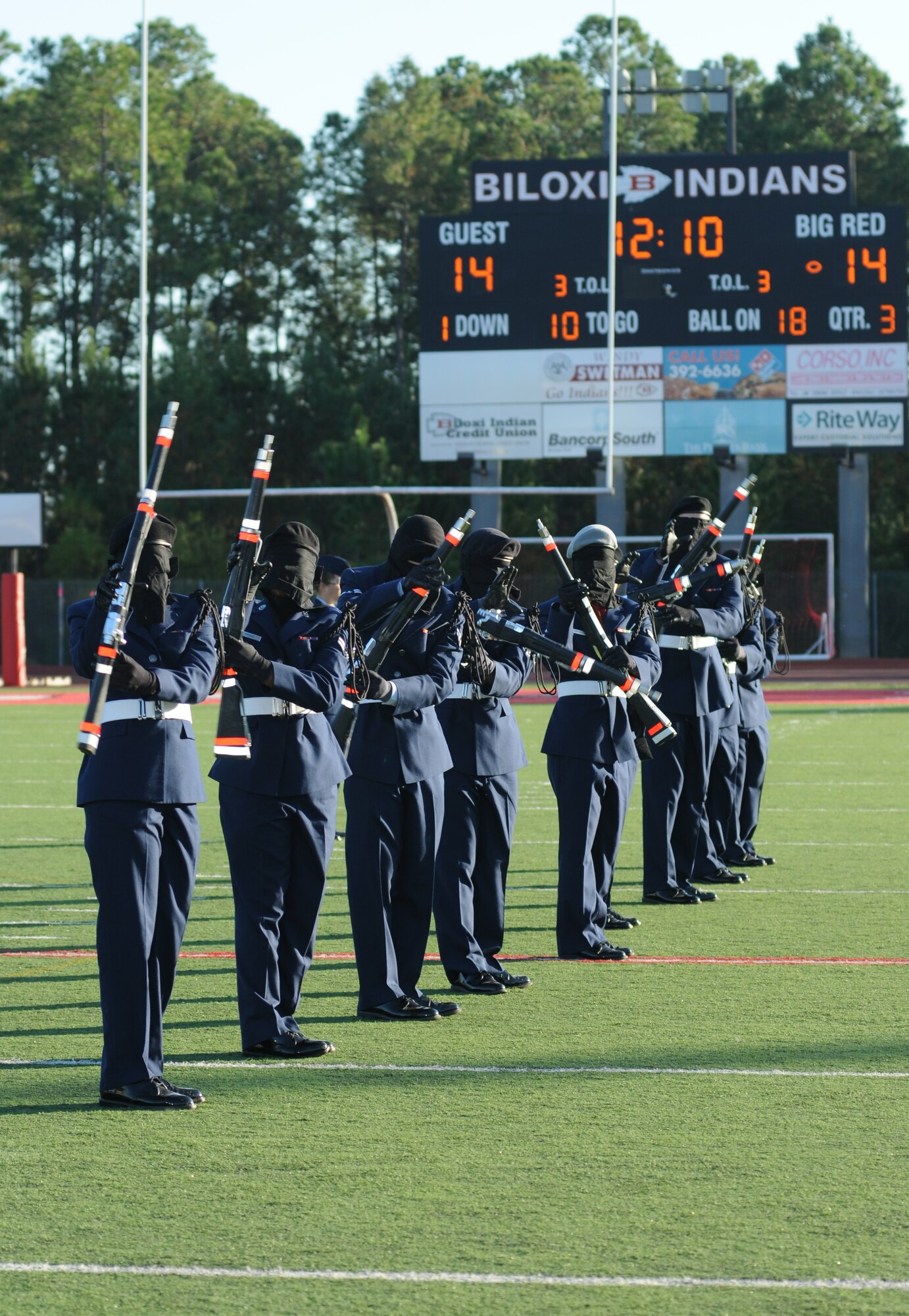 Members of the 335th Training Squadron drill team perform in a drill down competition during half time at the 2012 Mississippi Bowl at the Biloxi High School football stadium Dec. 2, 2012. The 336th Training Squadron was selected as the winner of the competition by audience applause.  Other participation from Keesler Air Force Base, Miss., included the 50-State Flag Team, the Honor Guard, and a C-130J Hercules fly over by the 403rd Wing.   (U.S. Air Force photo by Kemberly Groue)