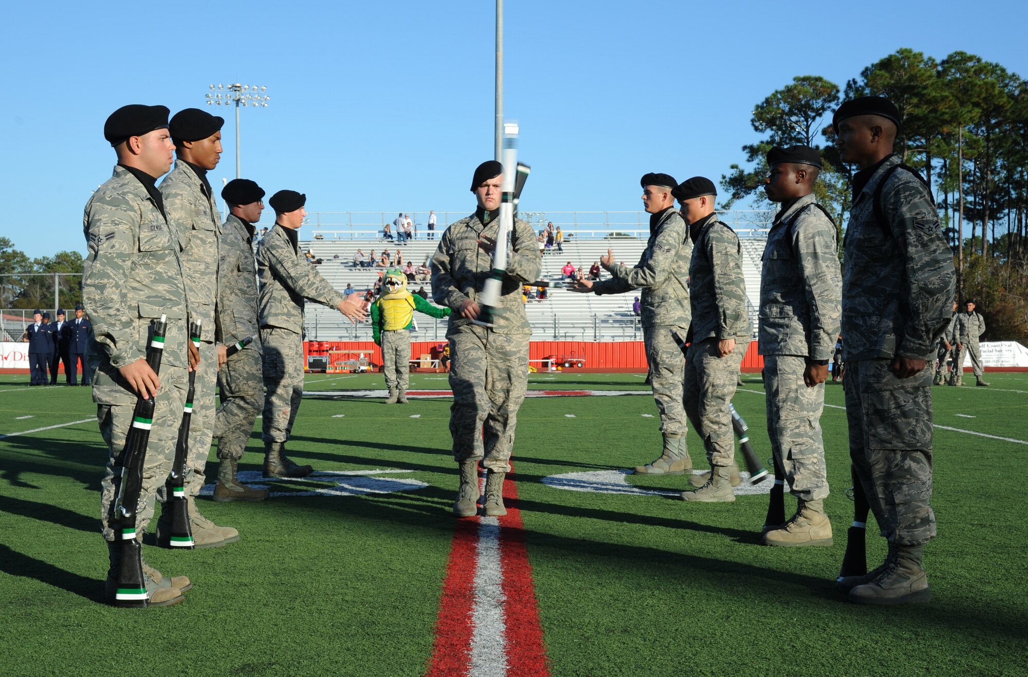 Members of the 334th Training Squadron drill team perform in a drill down competition during half time at the 2012 Mississippi Bowl at the Biloxi High School football stadium Dec. 2, 2012. The 336th Training Squadron was selected as the winner of the competition by audience applause.  Other participation from Keesler Air Force Base, Miss., included the 50-State Flag Team, the Honor Guard, and a C-130J Hercules fly over by the 403rd Wing.  (U.S. Air Force photo by Kemberly Groue)