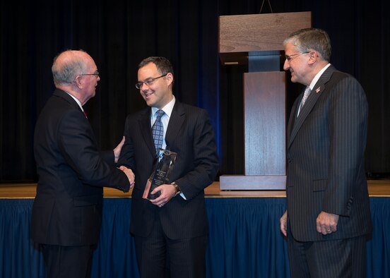 Daniel Ginsberg, the Air Force assistant secretary for Manpower and Reserve Affairs, accepts the Secretary of Defense Award for Achievements in Employment of Individuals with Disabilities, on behalf of the Air Force, from Frederick E. Vollrath, during the 32nd Annual Department of Defense Disability Awards Ceremony held in the Pentagon, Washington, D.C., on Dec. 04, 2012. Also pictured is Bob Corsi, Air Force assistant deputy chief of staff for Manpower, Personnel and Services. Vollrath currently performs the duties of assistant secretary of defense for readiness and force management. (U.S. Air Force photo/Jim Varhegyi) 
