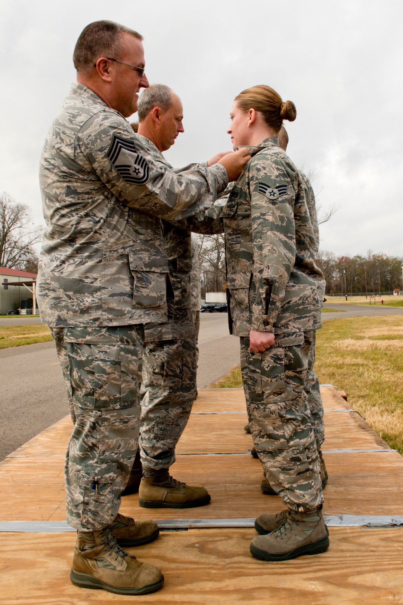 U.S. Air Force Chief Master Sgt. Joel Estes and Bobby Deshotel, recognize Airmen who were recently upgraded to a 5-Skill Level, Dec. 2, 2012, Barksdale Air Force Base, La. The Airmen are munitions technicians assigned to the 307th Maintenance Squadron and completed on-the-job training and the Course Development Program. (U.S. Air Force photo by Master Sgt. Greg Steele/Released)
