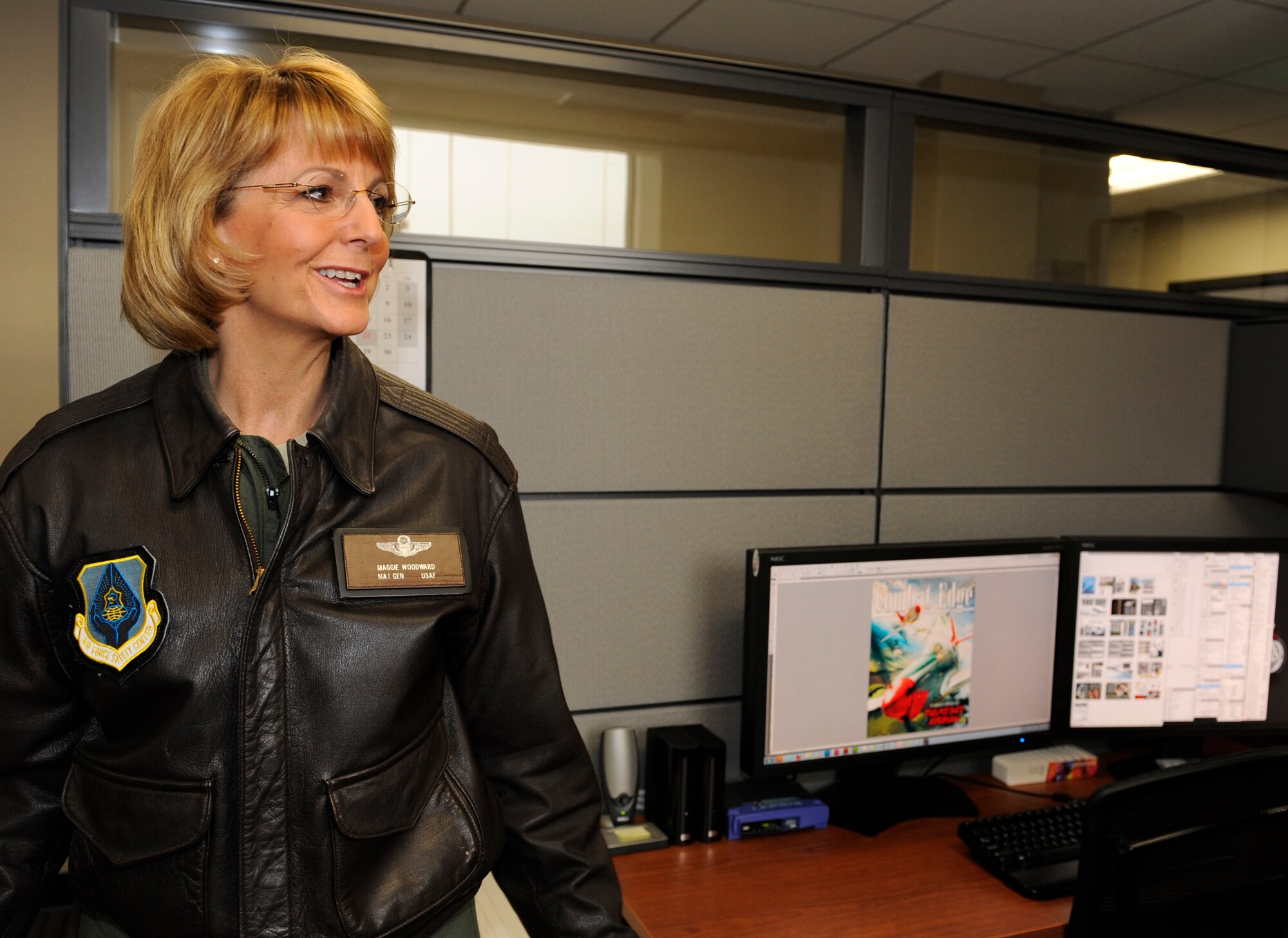 U.S. Air Force Maj. Gen. Margaret Woodward, Air Force Chief of Safety, comments on a Combat Edge magazine layout during a tour of Air Combat Command Safety headquarters, Joint Base Langley-Eustis, Va., Nov. 27, 2012. Combat Edge is the official ACC Safety magazine distributing safety messages, firsthand accounts, and advice across the command. (U.S. Air Force photo by Staff Sgt. Krystie Martinez/Released)