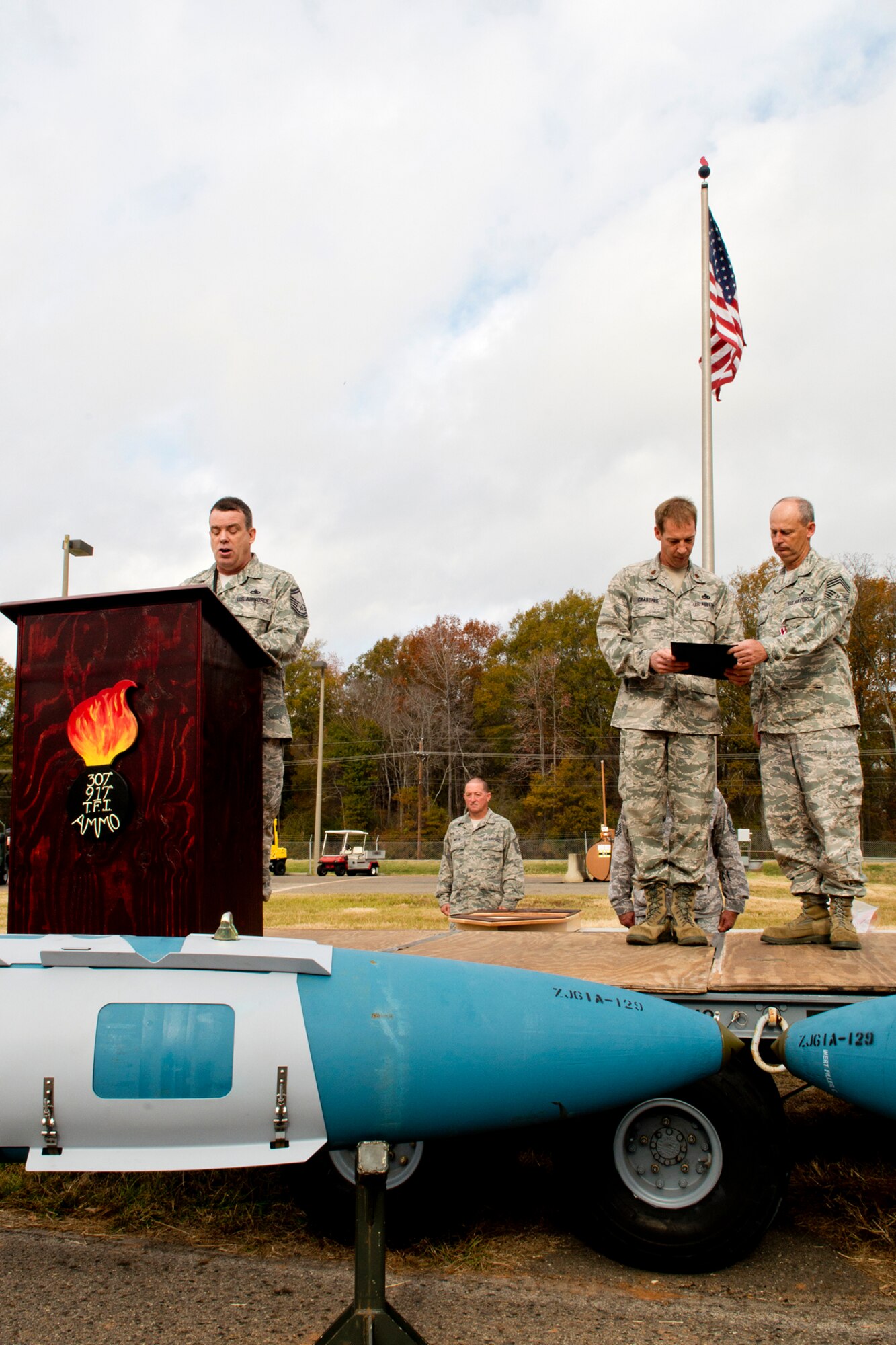 U.S. Air Force Senior Master Sgt. Philip Webber reads the retirement orders during a ceremony for Chief Master Sgt. Bobby Deshotel, Dec. 2, 2012, Barksdale Air Force Base, La. Deshotel is a munitions flight chief assigned to the 307th Maintenance Squadron and is retiring after serving over 24 years in the military. (U.S. Air Force photo by Master Sgt. Greg Steele/Released)