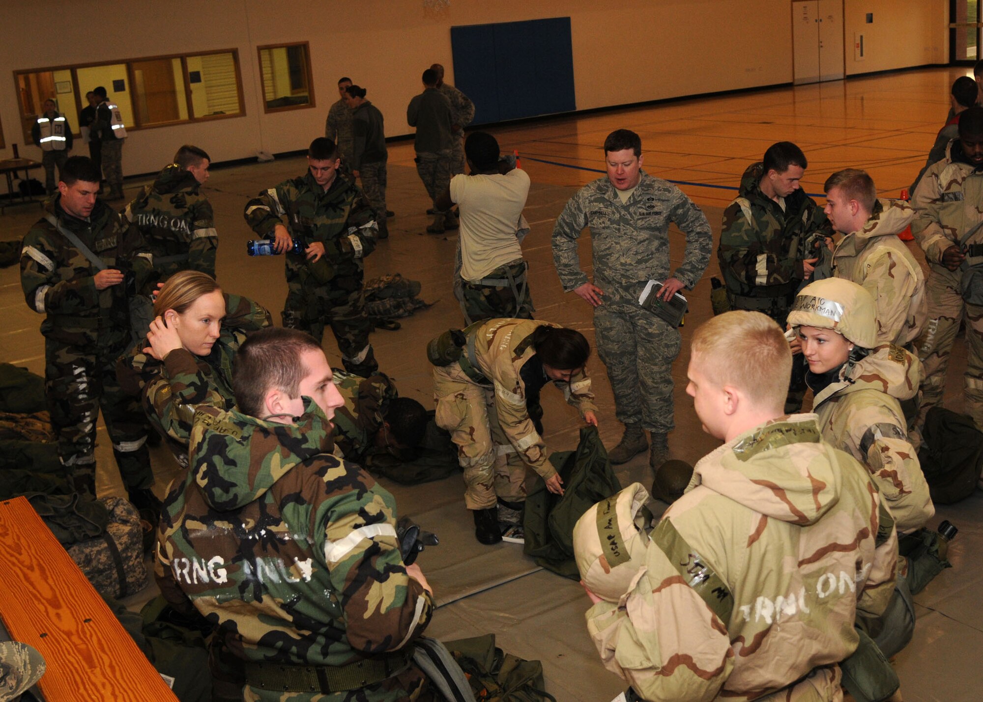 Staff Sgt. Ian Campbell, 100th Civil Engineer Squadron logistics emergency management NCO in charge from Louisville, Ky., briefs Airmen on the exercises going on at the Ability to Survive and Operate Rodeo Dec. 5, 2012, in the Hardstand Fitness Center at RAF Mildenhall, England. The rodeo had many different sections to include self-aid and buddy care and chemical, biological, radioactive and nuclear training. (U.S. Air Force photo by Airman 1st Class Kelsey Waters/Released)