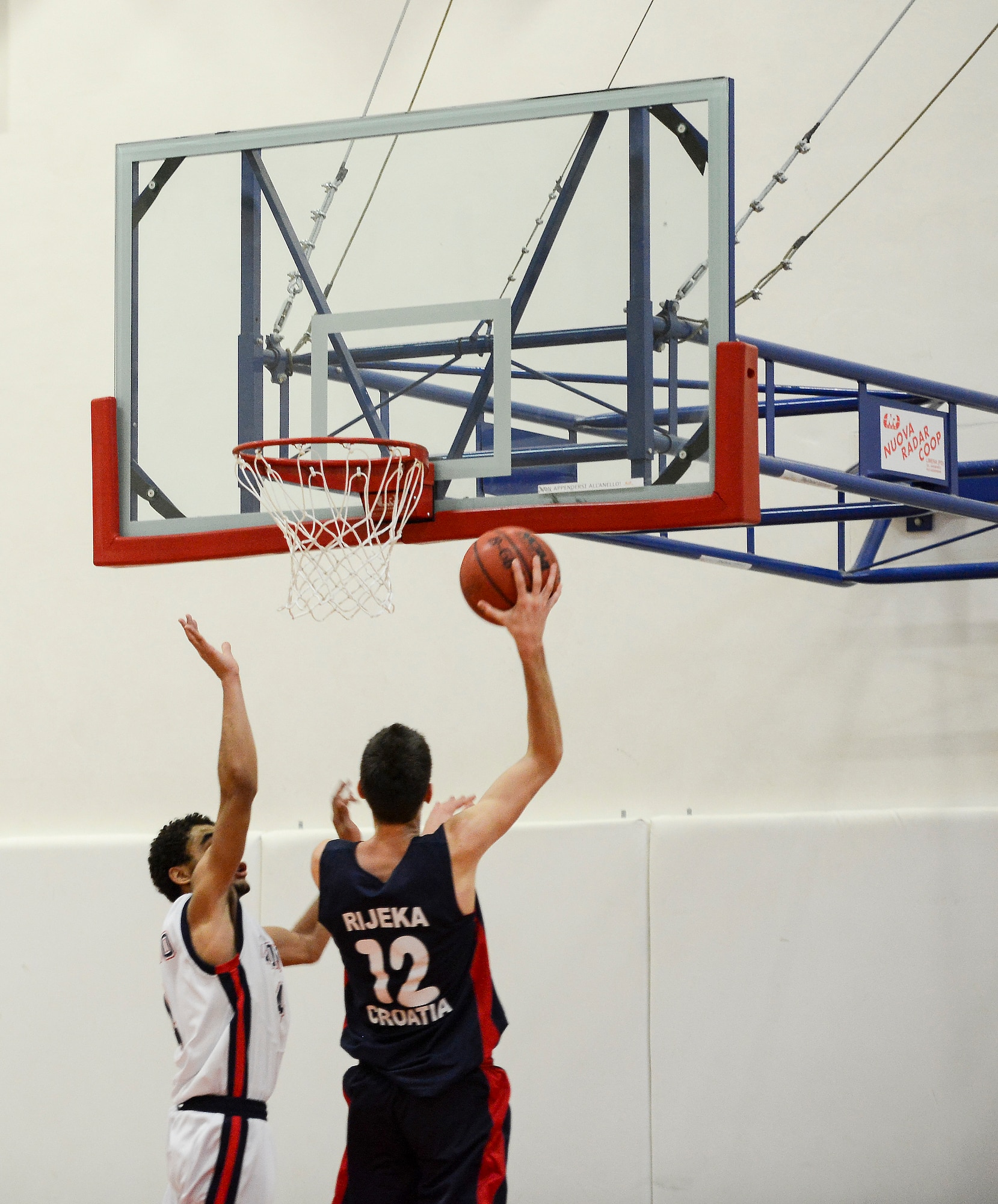 A Croatian player attempts to score against the Aviano High School men’s basketball team during a game Dec. 1 at Aviano Air Base, Italy. The team from Rijeka, Croatia visited Aviano from Nov. 29 to Dec. 2, and bonded with the AHS team while playing basketball and touring the base and area with their host families. (U.S. Air Force photo by Senior Airman Katherine Tereyama)