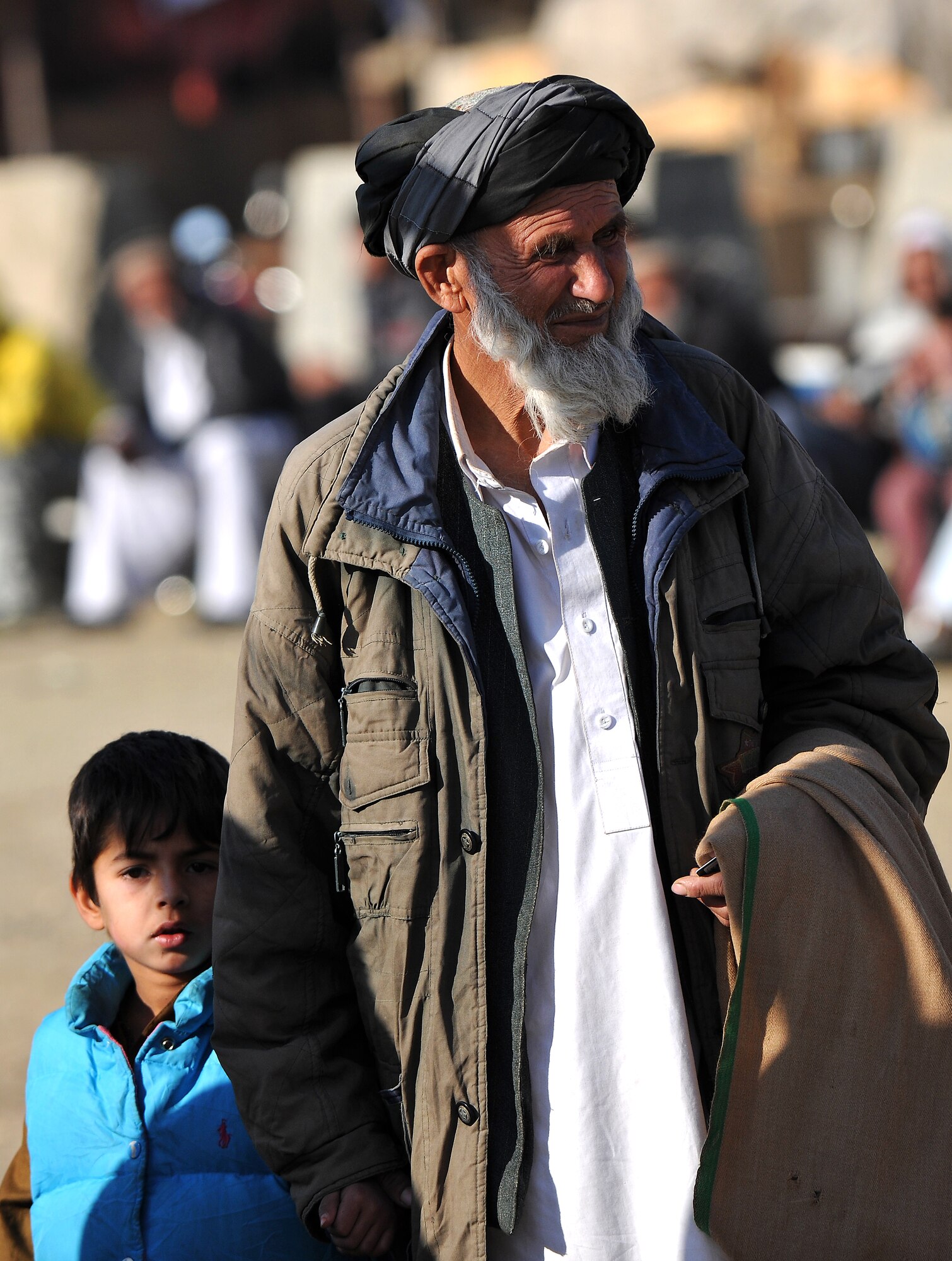 Local Afghans wait to process through the medical entry control point at Bagram Airfield, Afghanistan, Dec. 2, 2012.  Members of the 455th Expeditionary Security Forces Group bravo sector and Afghan local guards process as many as 400 people from outside the gate needing services ranging from basic clinical care to student vocational programs.  (U.S. Air Force photo/Senior Airman Chris Willis)