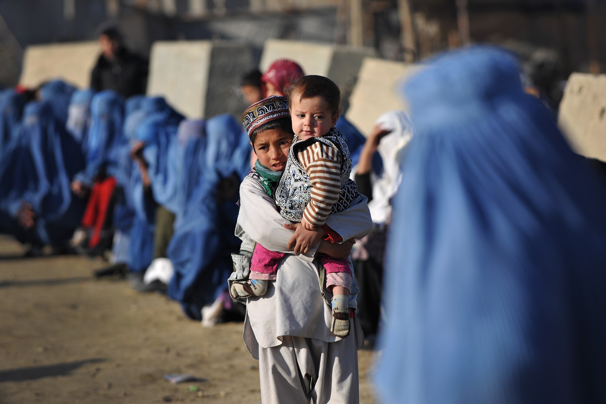 Local Afghans wait to process through the medical entry control point at Bagram Airfield, Afghanistan, Dec. 2, 2012.  Members of the 455th Expeditionary Security Forces Group bravo sector and Afghan local guards process as many as 400 people from outside the gate needing services ranging from basic clinical care to student vocational programs.  (U.S. Air Force photo/Senior Airman Chris Willis)