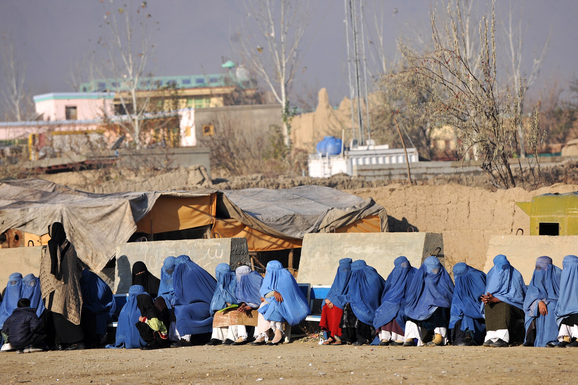 Local Afghan women wait to process through the medical entry control point at Bagram Airfield, Afghanistan, Dec. 2, 2012.  Members of the 455th Expeditionary Security Forces Group bravo sector and Afghan local guards process as many as 400 people from outside the gate needing services ranging from basic clinical care to student vocational programs.  (U.S. Air Force photo/Senior Airman Chris Willis)