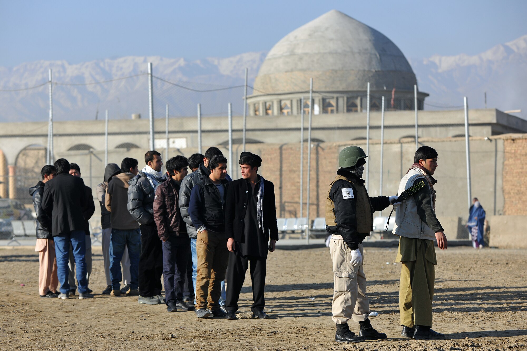An Afghan guard searches members of the local community before sending them through the medical entry control point at Bagram Airfield, Afghanistan, Dec. 2, 2012.  Members of the 455th Expeditionary Security Forces Group bravo sector and Afghan local guards process as many as 400 people from outside the gate needing services ranging from basic clinical care to student vocational programs.  (U.S. Air Force photo/Senior Airman Chris Willis)