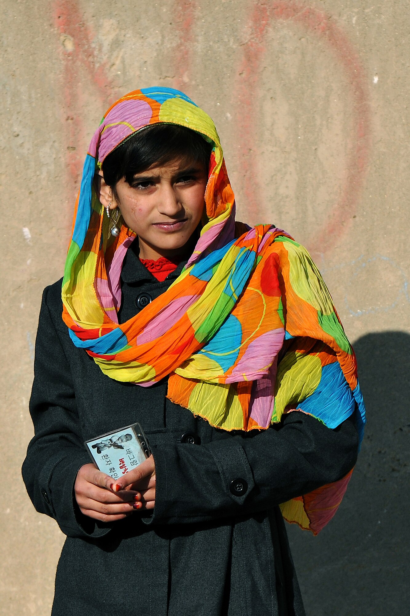 A local Afghan girl waits to be processed through the medical entry control point at Bagram Airfield, Afghanistan, Dec. 2, 2012.  455th Expeditionary Security Forces Group entry control point Airmen and Afghan local guard provide security and collect information to identify and track records for all incoming patients.  (U.S. Air Force photo/Senior Airman Chris Willis)