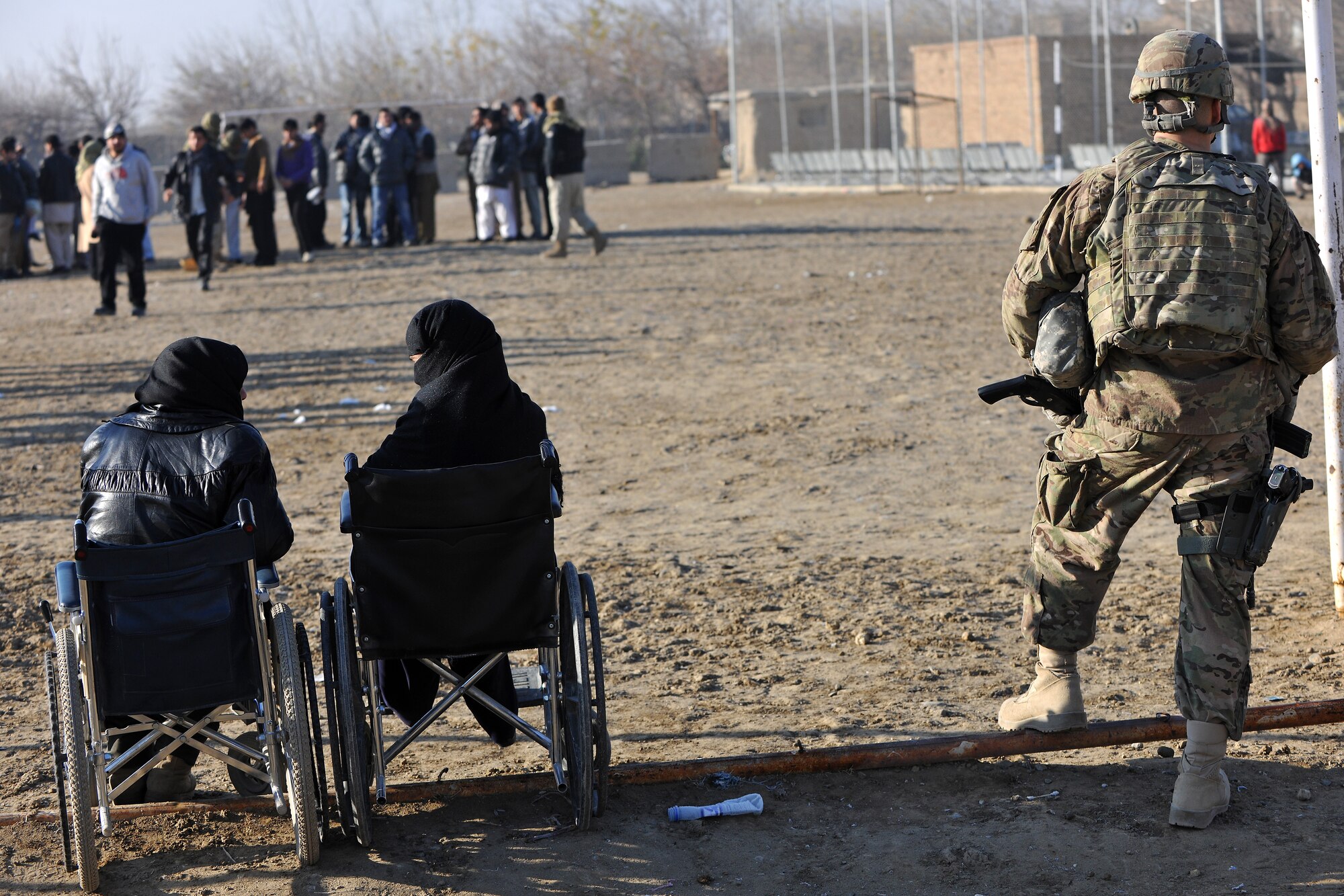 Staff Sgt. John Silvia, 455th Expeditionary Security Forces Group entry control point NCOIC, patrols the area outside the medical entrance at Bagram Airfield, Afghanistan, Dec. 2, 2012.  455 EFSG teams patrol the base perimeter looking for suspicious activities while local Afghan civilians arrive to receive basic medical care.  (U.S. Air Force photo/Senior Airman Chris Willis)