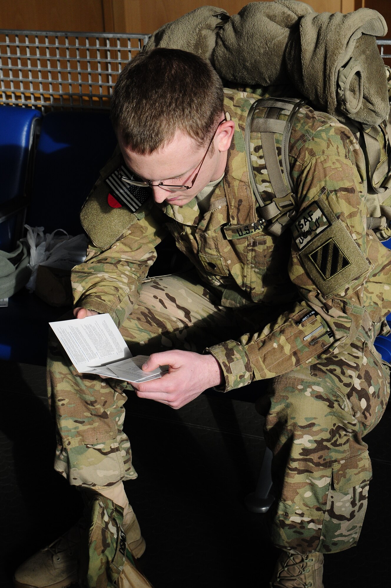 Army Spc. Zachary Disney, from Indianapolis, Indiana, reads a letter given to him from Project Rudolph at the passenger terminal Dec. 4, 2012, on Ramstein Air Base, Germany. Project Rudolph was started in 2006 by a family who wanted to give to service members over the holidays. (U.S. Air Force photo/Airman 1st Class Hailey Haux)