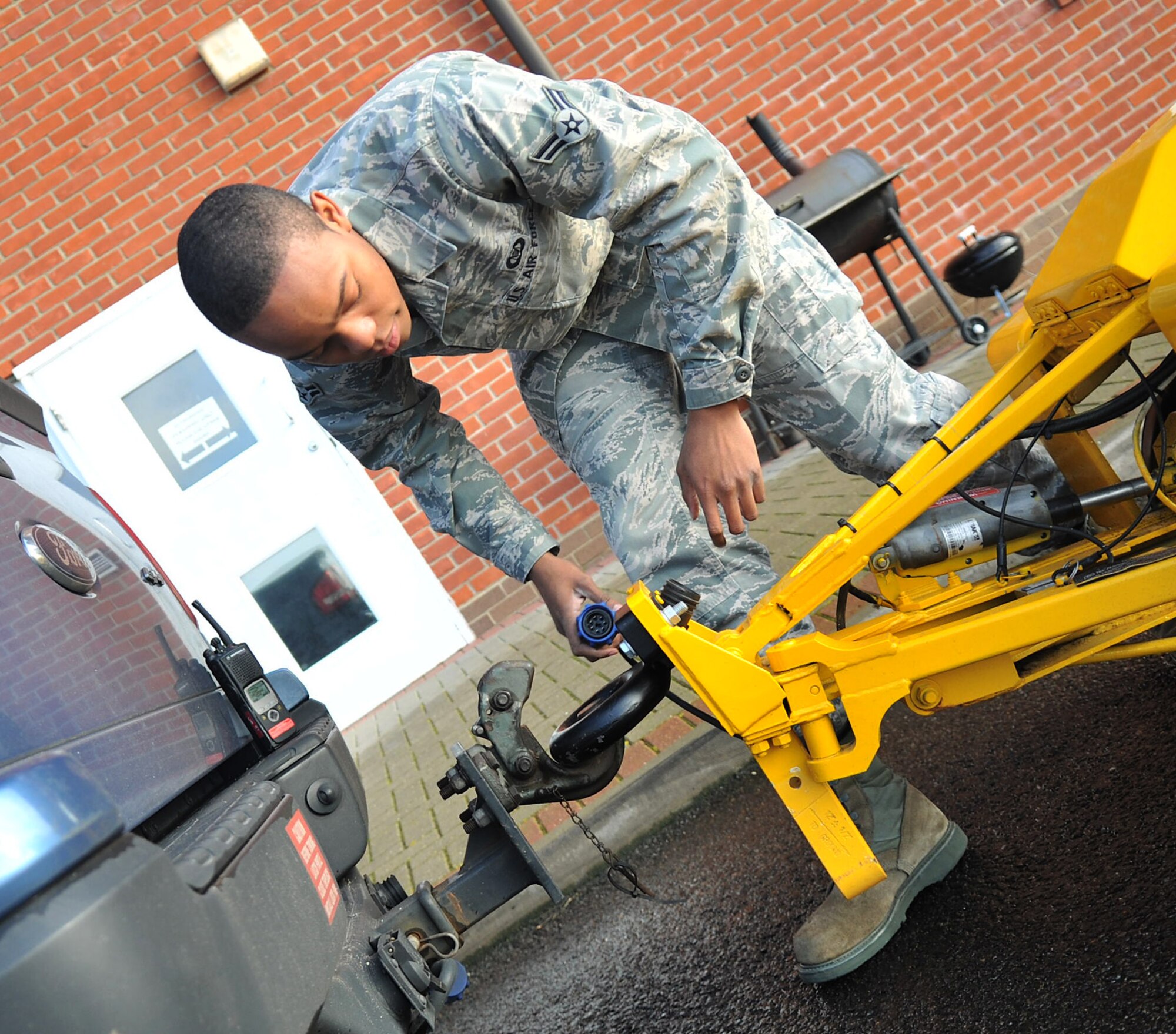 Airman 1st Class Quentin Austin, 100th Operations Support Squadron airfield management shift lead, hooks up a Mu meter to a government vehicle Dec. 5, 2012, at RAF Mildenhall, England. (U.S. Air Force photo by Senior Airman Jerilyn Quintanilla)