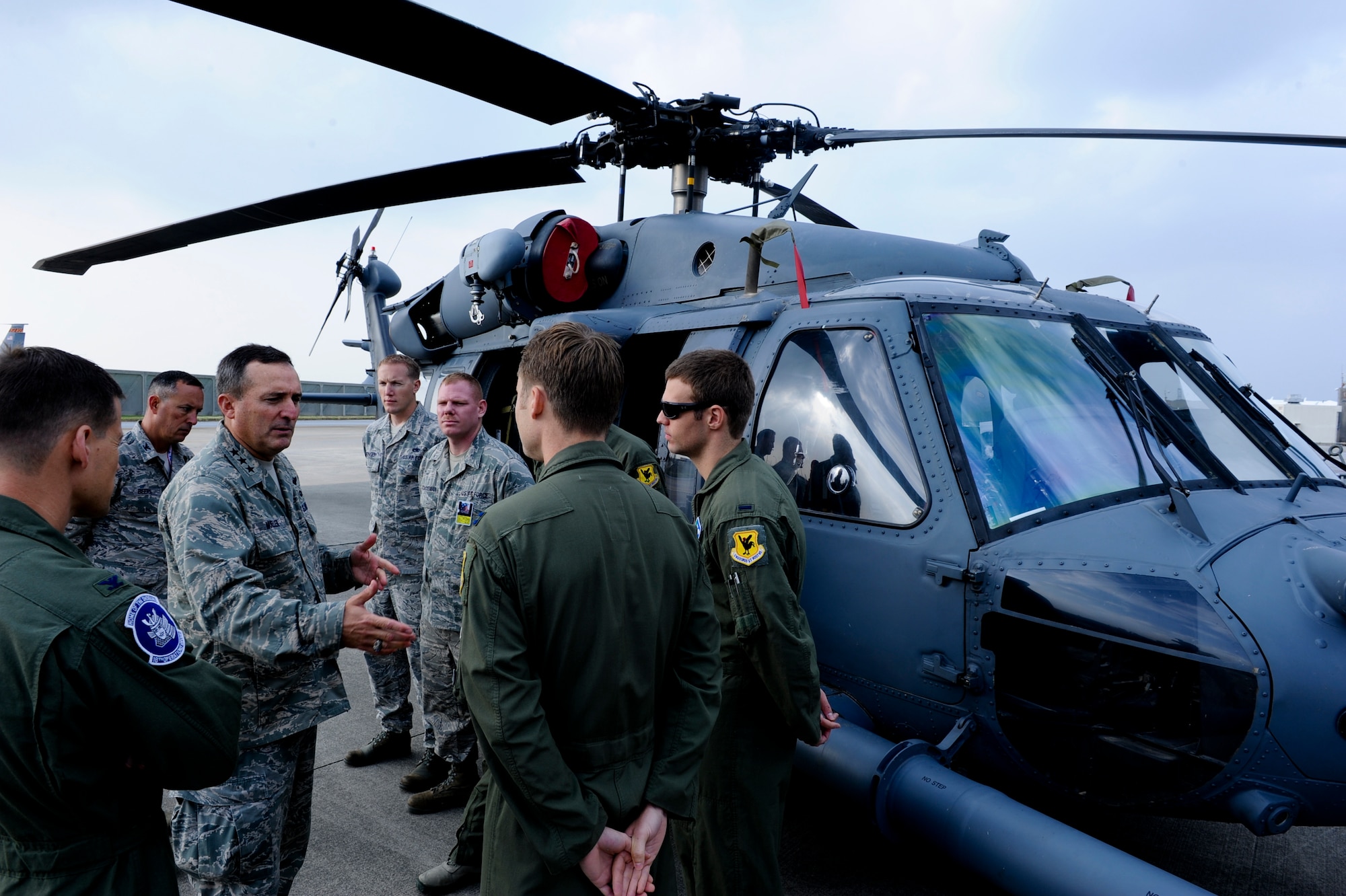 U.S. Air Force Lt. Gen. Stephen Mueller, Inspector General of the Air Force, discusses the importance of hard work to Capt. Gavin Johnson, 1st Lt. Matthew Pfarr, both HH-60 Pavehawk pilots, and Tech. Sgt. Scott Lagerveld, flight engineer, during his visit on Kadena Air Base, Japan, Dec.4, 2012. Mueller visited Kadena during his Pacific Air Force Orientation Tour. He was here to get a better understanding of Pacific Air Force's operations and address any issues and concerns of Airmen in the region. (U.S. Air Force photo/Airman 1st Class Justin Veazie)
