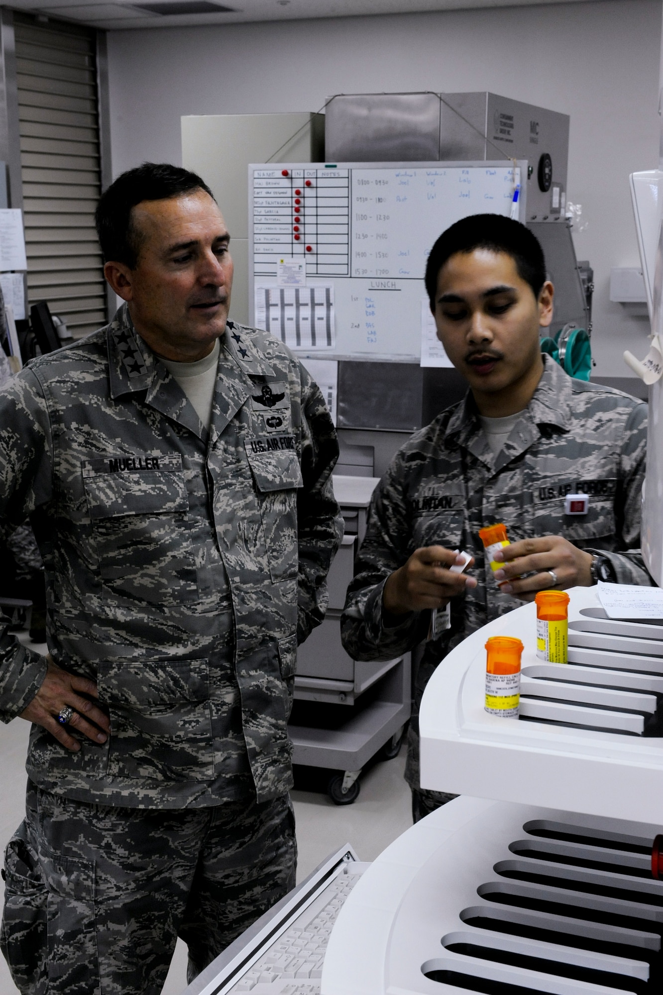 U.S. Air Force Senior Airman Joel Polintan, 18th Medical Group pharmacy apprentice, explains the function of the PhamASSIST Robotx, an automated medicine dispensing unit, to U.S. Air Force Lt. Gen. Stephen Mueller,  Inspector General of the Air Force, during his visit to Kadena Air Base, Japan, Dec. 4, 2012. Mueller's direct interaction with Kadena Airmen generated discussion that he will take back to the Pentagon. (U.S. Air Force photo/Airman 1st Class Justin Veazie)
