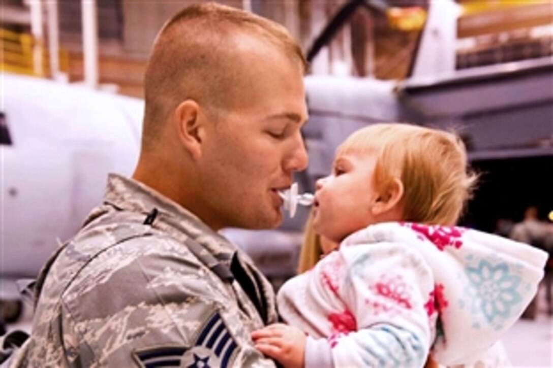 Air Force Staff Sgt. Jason Mann enjoys a playful moment with his daughter upon his return from a deployment to Robins Air Force Base Ga., Dec 3, 2012. Mann is assigned to the 116th Maintenance Squadron, Georgia Air National Guard. About 50 Team JSTARS operations, maintenance and support personnel returned home from a three-month deployment from  the Middle East. 